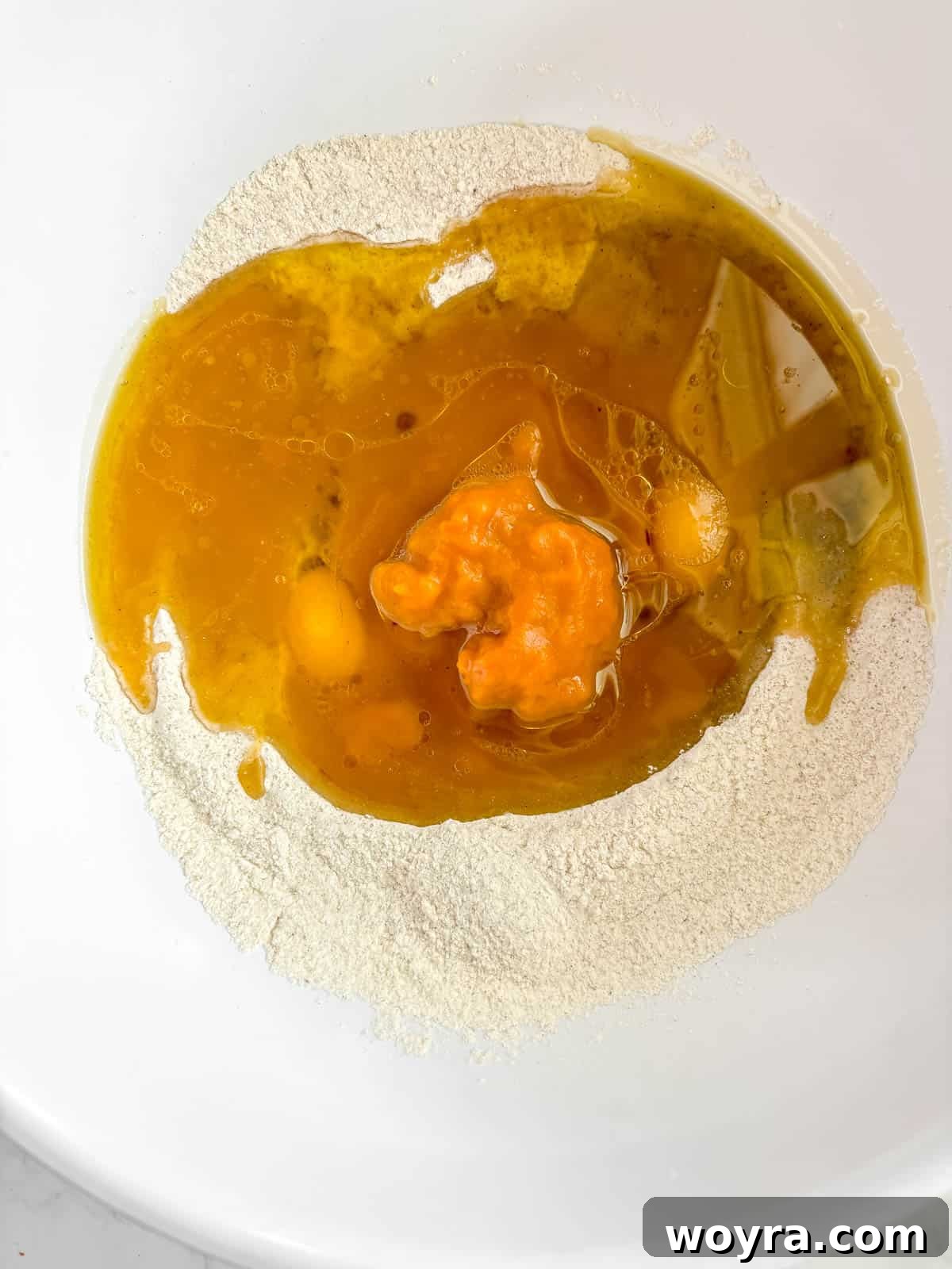 Wet ingredients poured into the well of dry ingredients.