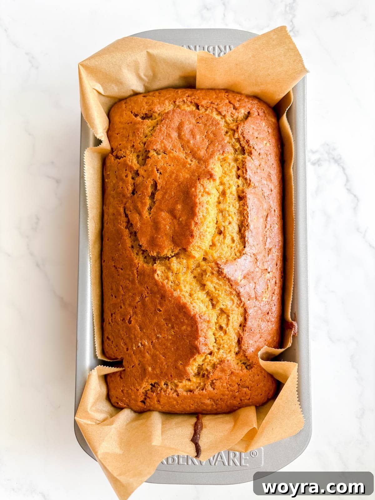 A perfectly baked dairy-free pumpkin bread cooling on a wire rack.