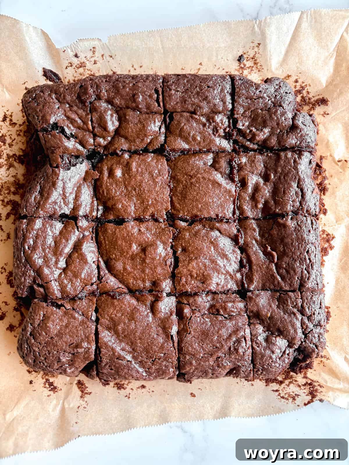 Silky Olive Brownies 11 A chef meticulously cutting the thoroughly cooled olive oil brownies into even, delectable squares, revealing their dense and rich interior.