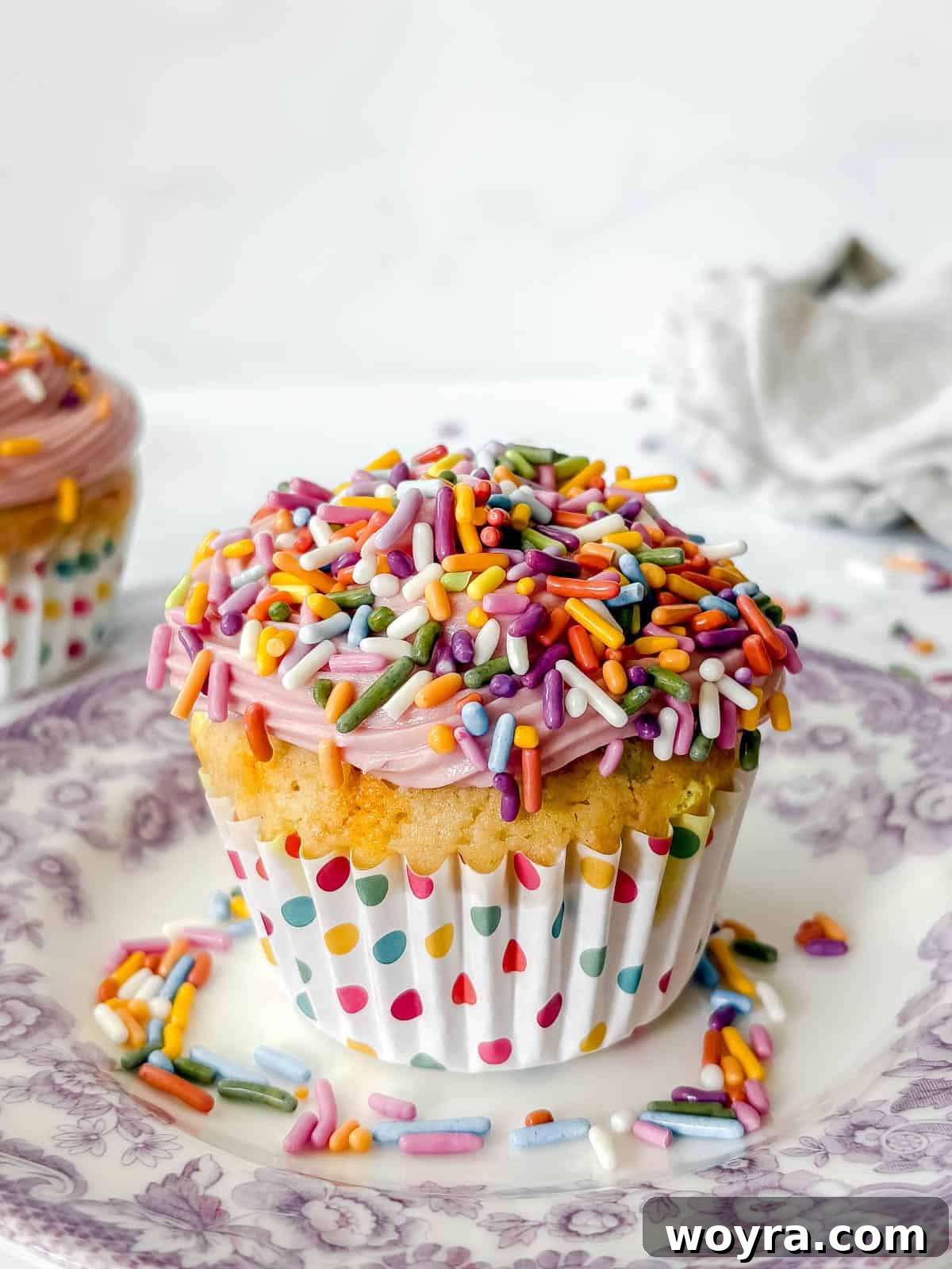 Whimsical Small Batch Funfetti Cupcakes 12 A beautifully frosted funfetti cupcake topped with a generous amount of rainbow sprinkles.