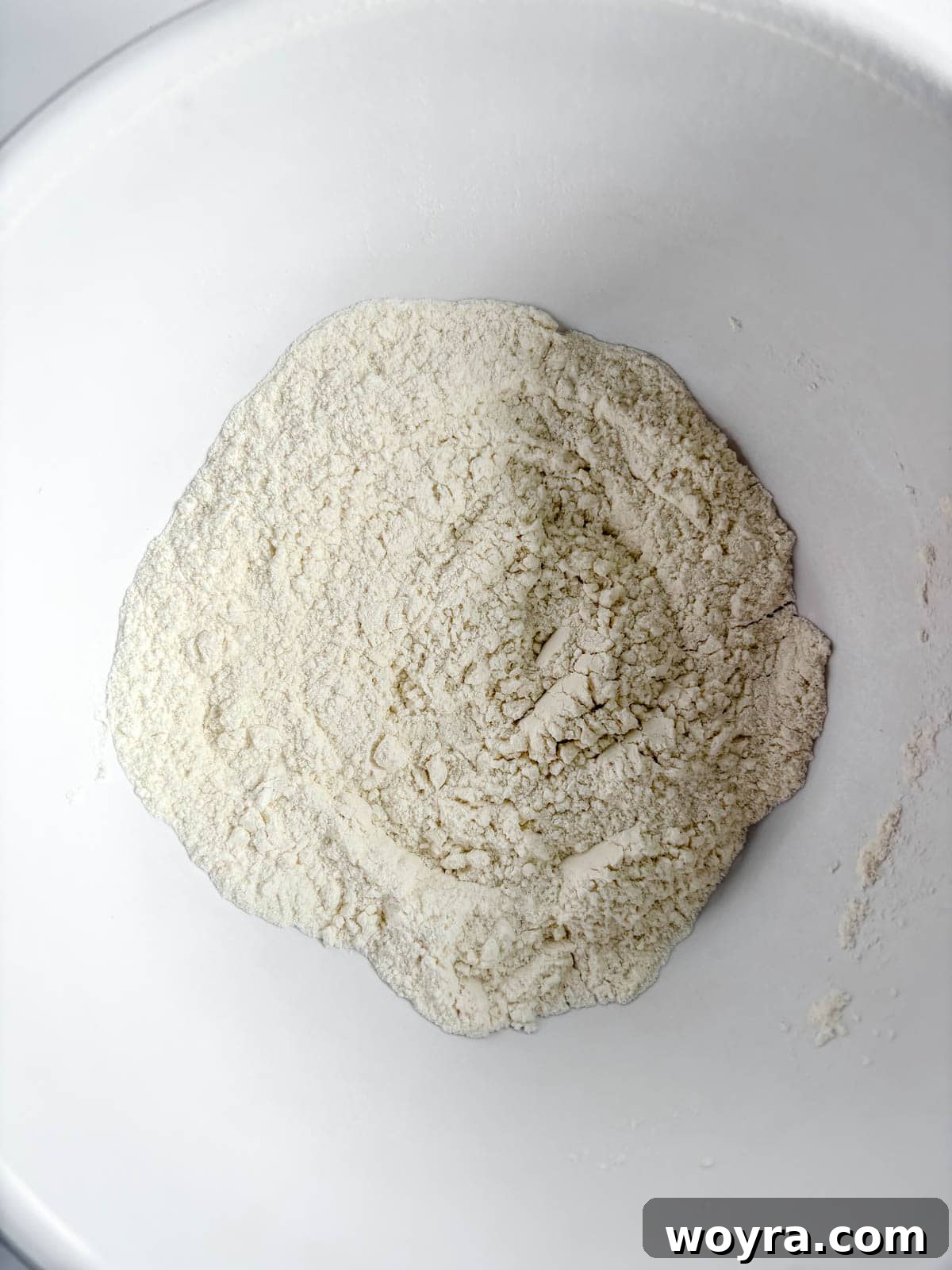 Whimsical Small Batch Funfetti Cupcakes 5 Dry ingredients, including flour, baking powder, and salt, in a mixing bowl.