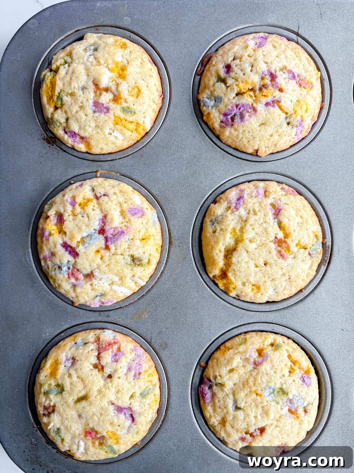 Whimsical Small Batch Funfetti Cupcakes 10 Six freshly baked funfetti cupcakes with golden-brown tops, removed from the oven and cooling.