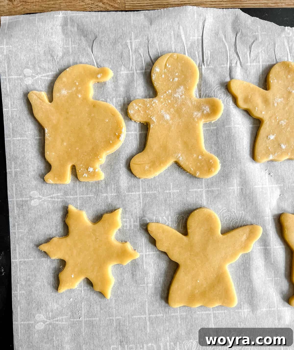 Perfectly Shaped Sable Delights 12 Sable cut out sugar cookies placed on a baking sheet before going into the oven.