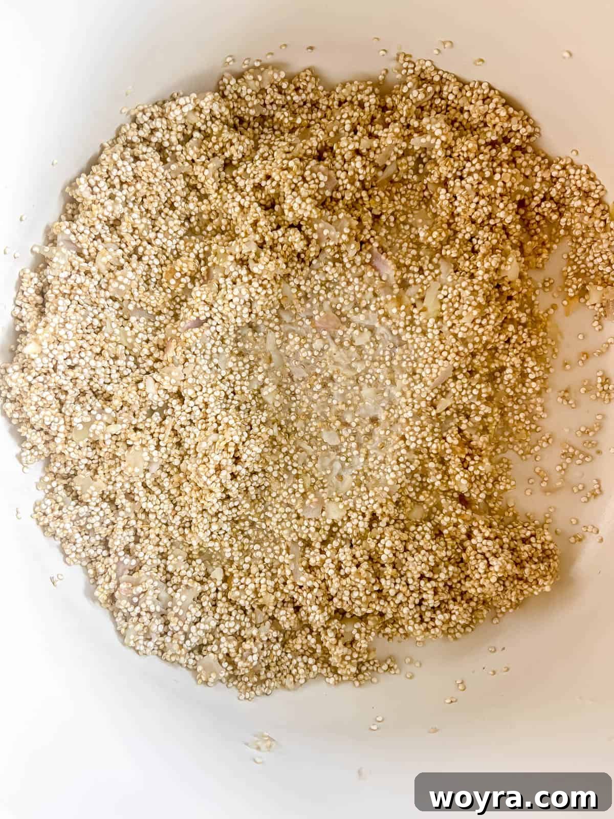 Velvety Mushroom Quinoa Risotto 6 Uncooked quinoa added to the pan with sautéed shallots and garlic, ready to be toasted.