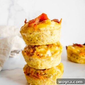 Sweet Potato Bacon Breakfast Nests 10 Sweet Potato Egg Cups with Bacon stacked on top of each other, showcasing the golden brown tops.