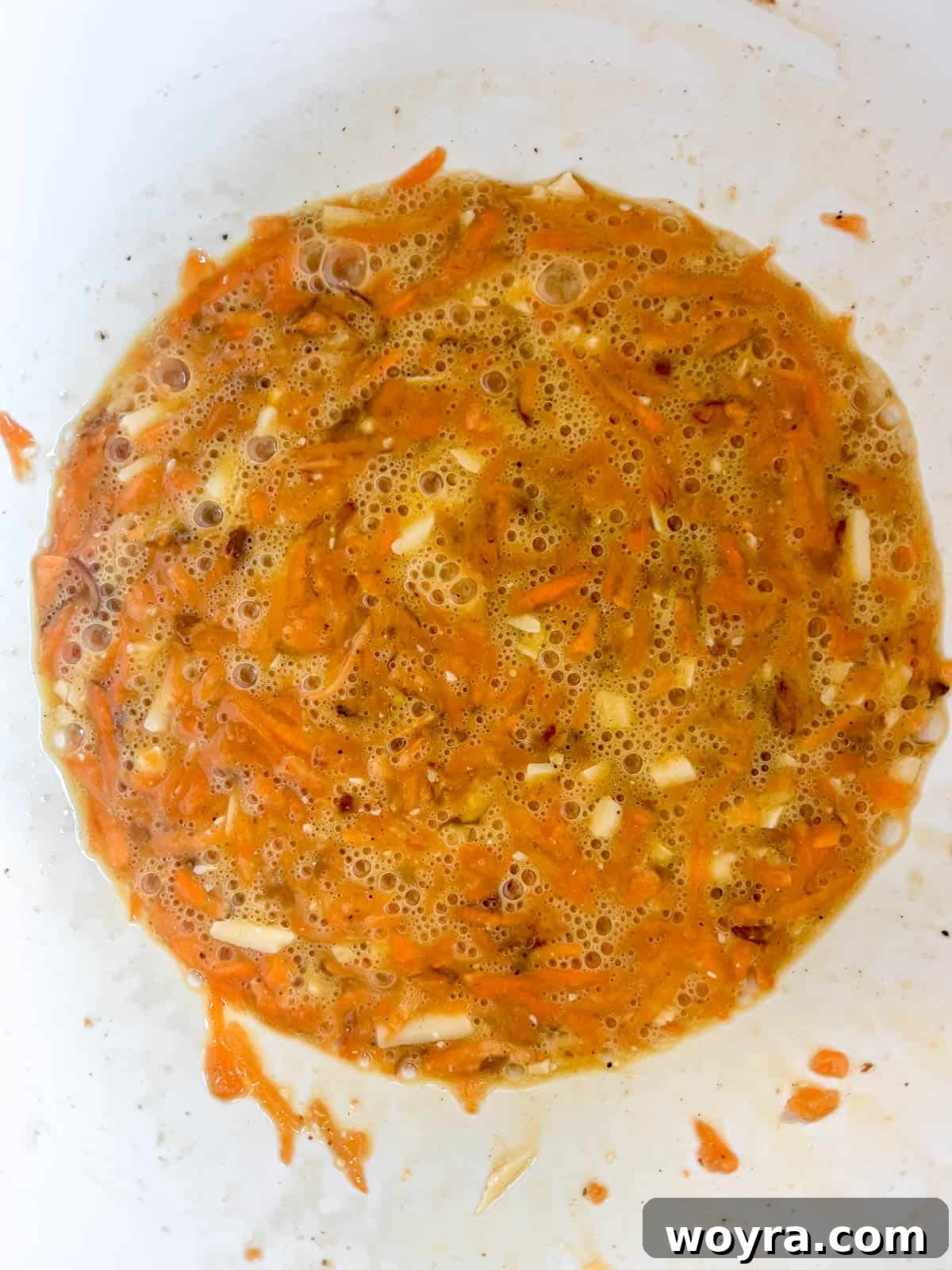 Sweet Potato Bacon Breakfast Nests 6 Shredded sweet potato and cheese added to the egg mixture, ready to be combined.