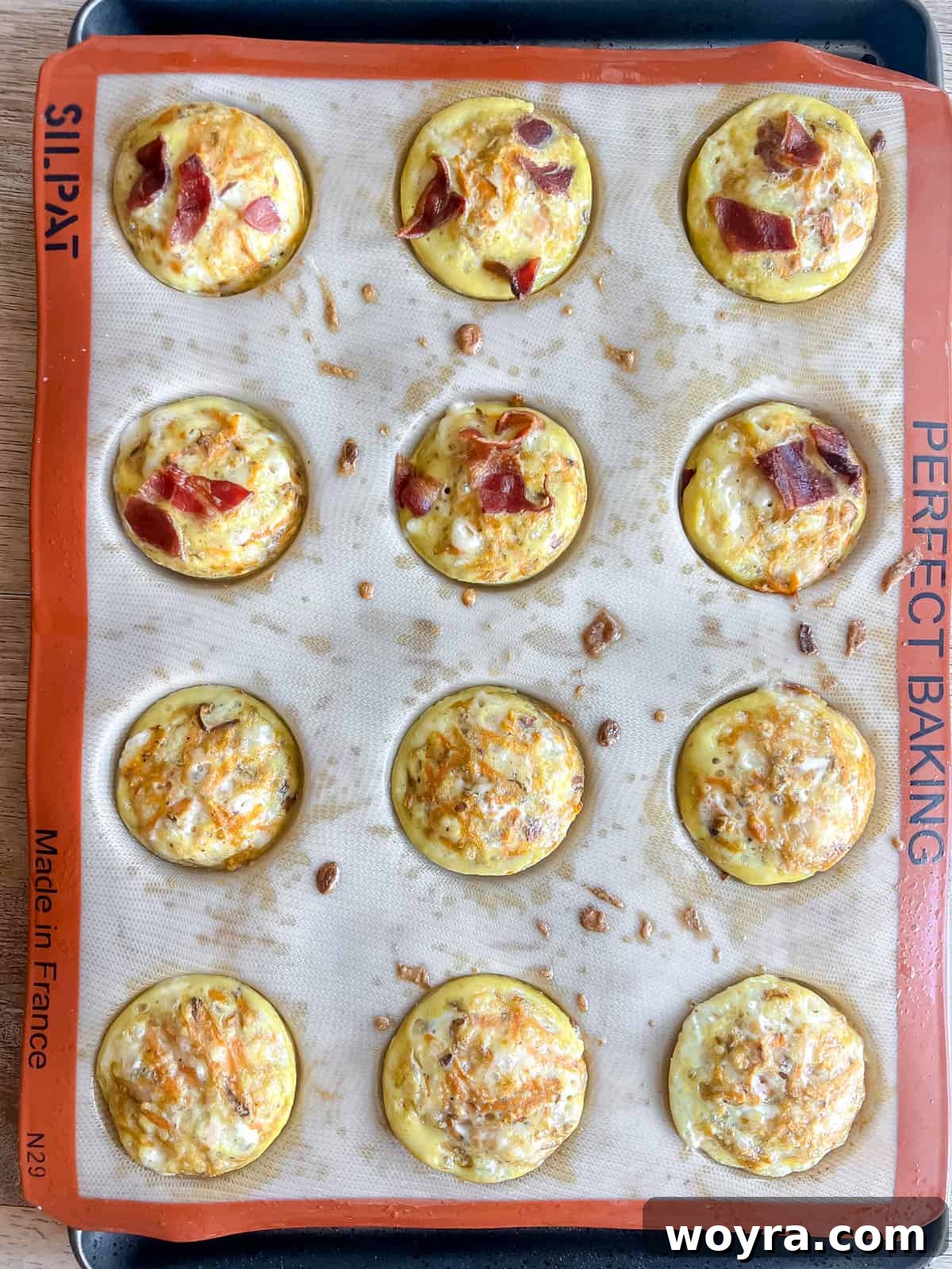 Sweet Potato Bacon Breakfast Nests 8 Baked sweet potato egg cups with bacon, golden brown and cooked through, cooling in the muffin tin.