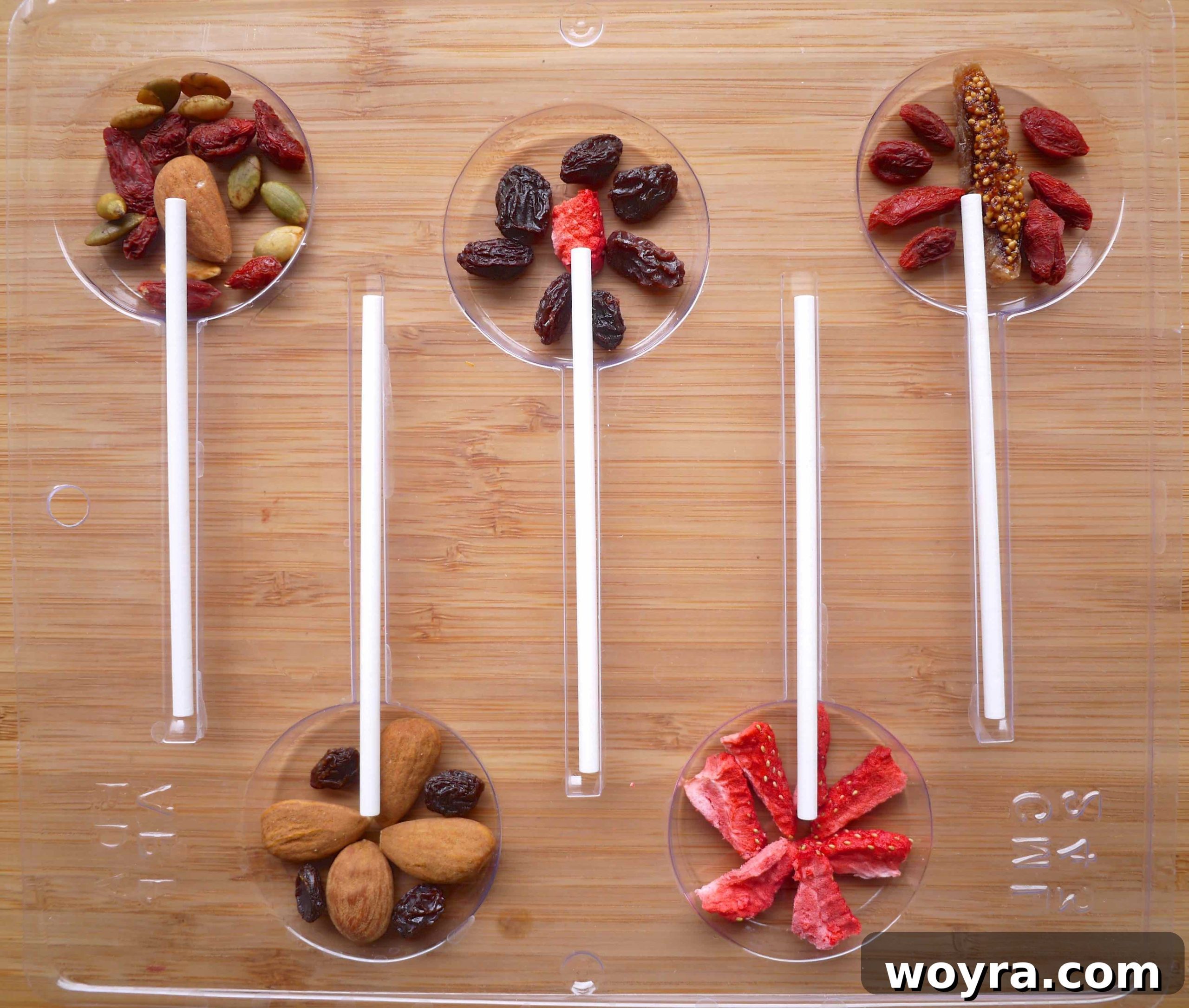 Artisan Chocolate Fruit Pops 4 Inserting lollipop sticks carefully into the prepared chocolate molds, positioning them centrally.