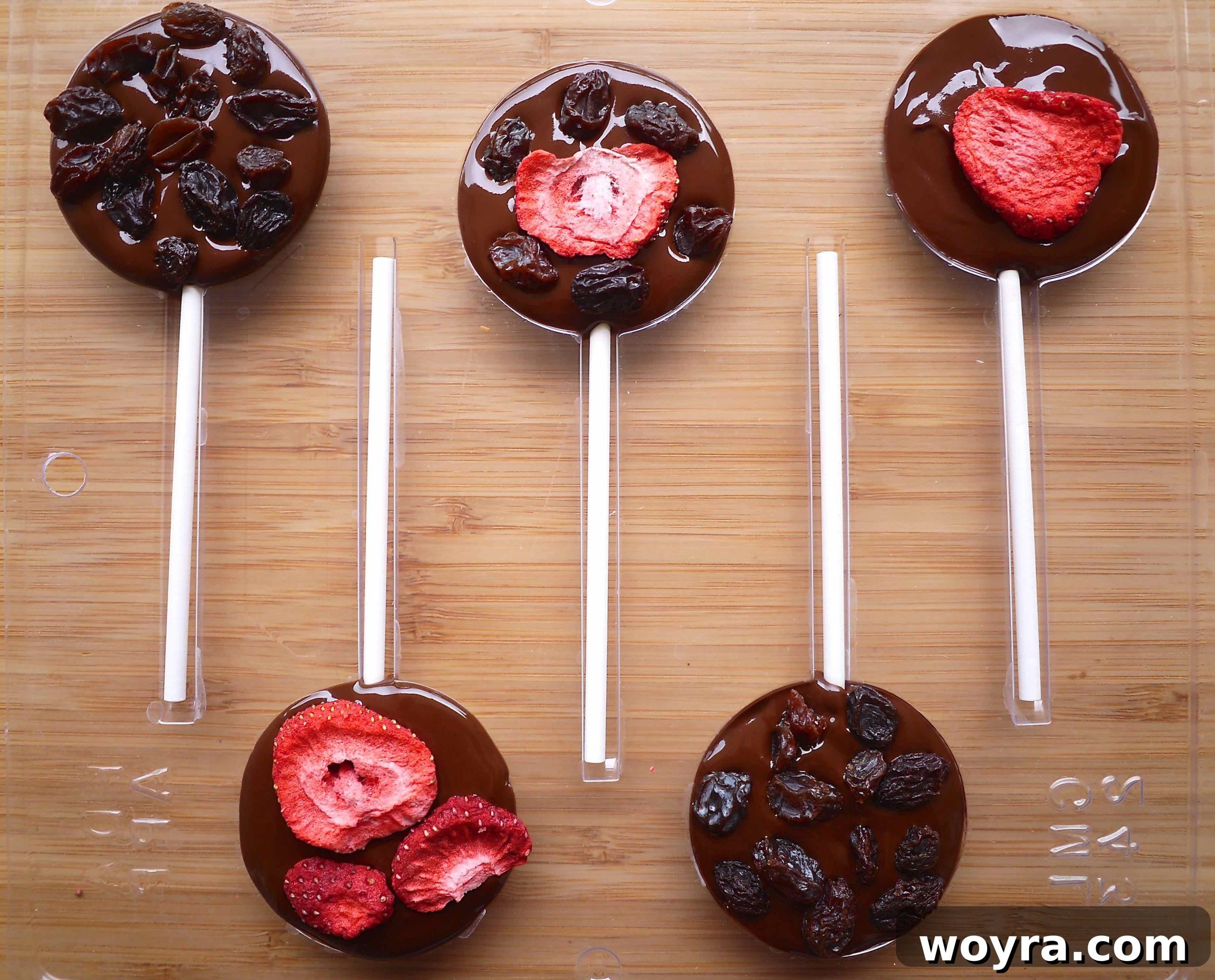 Artisan Chocolate Fruit Pops 7 Adding additional dried fruit and nuts on top of the freshly poured melted chocolate in the molds for a double-sided design.