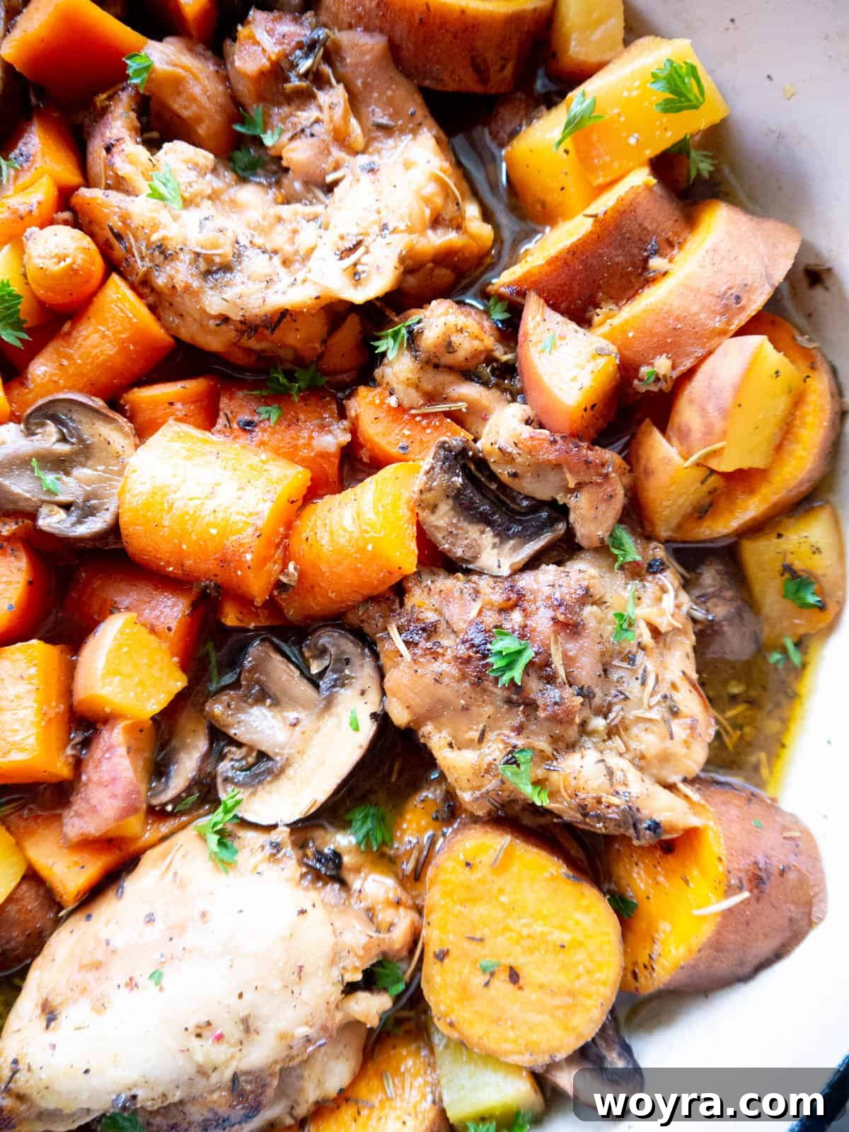Freshly cooked Dutch Oven Maple Peach Chicken Thighs, showcasing golden-brown chicken and colorful vegetables.