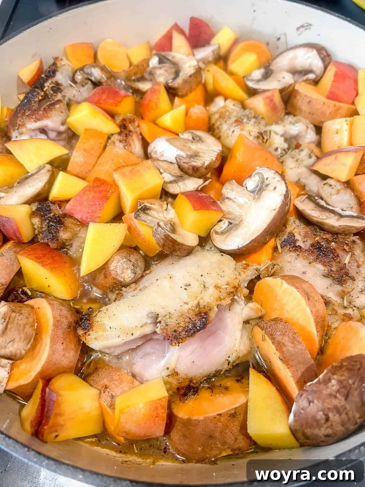 The Dutch oven chicken thighs and vegetables simmering gently, uncovered, for a few minutes.