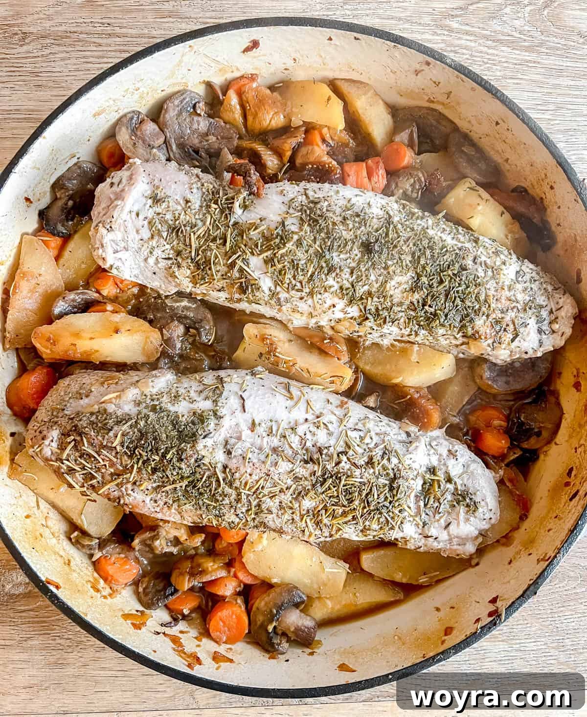 Dutch Oven Pork Tenderloin with Spiced Apples and Figs 8 The Dutch oven, covered with its lid, prepared for baking the pork tenderloin with apples and figs in the oven. The tight-fitting lid ensures even cooking and moisture retention.