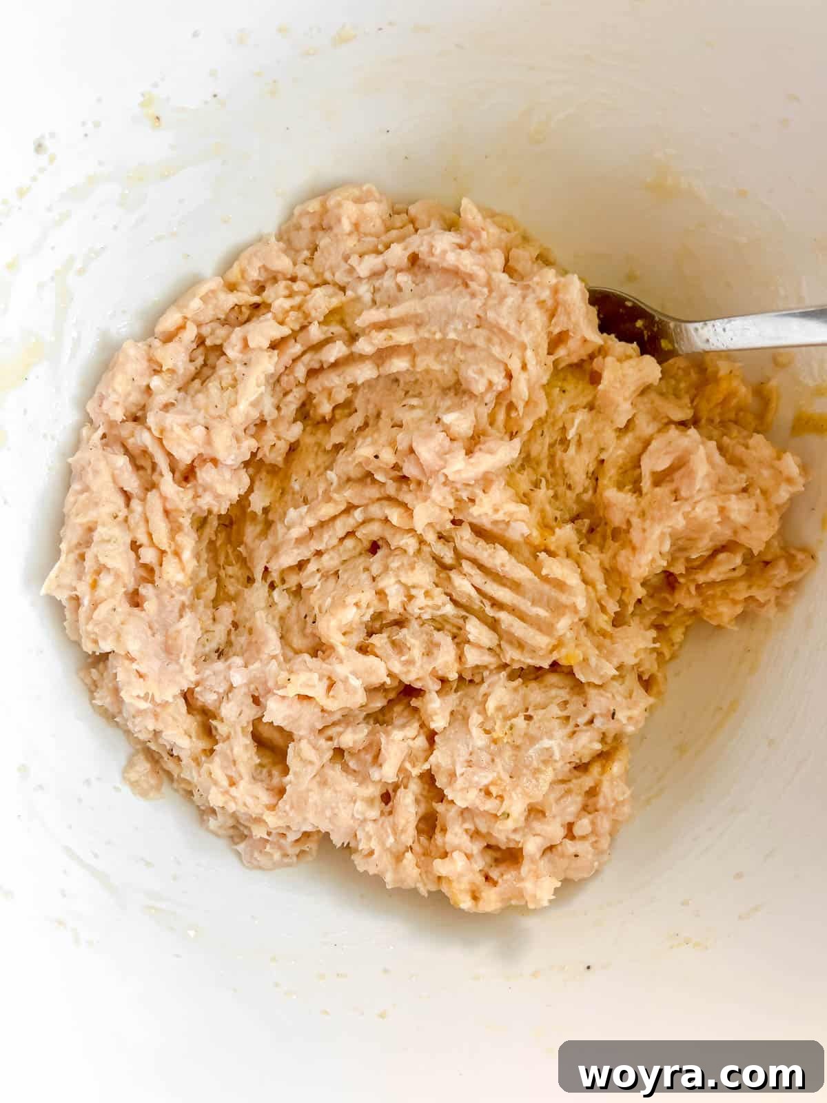 Ground chicken burger mixture in a bowl, ready for shaping.