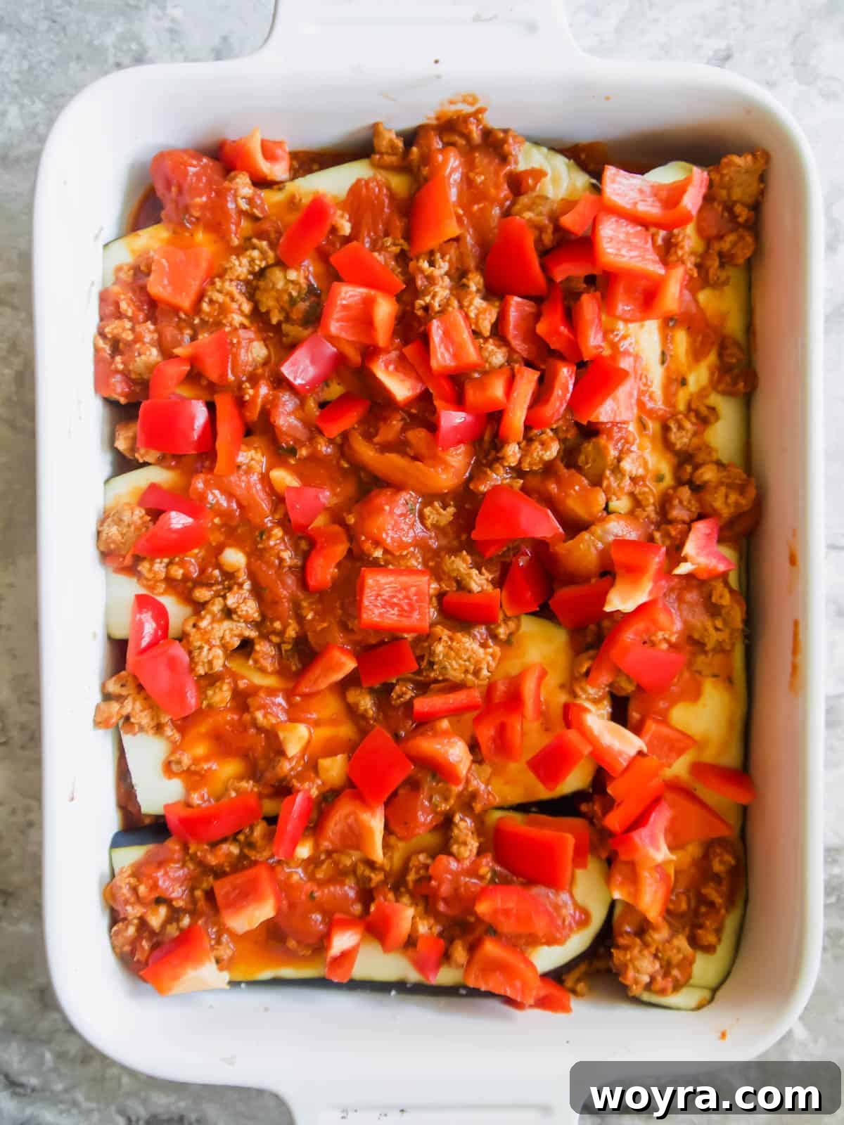 Rustic Turkey and Veggie Gratin 7 A vibrant layer of red bell peppers and more meat sauce added to the casserole dish, building the delicious layers.