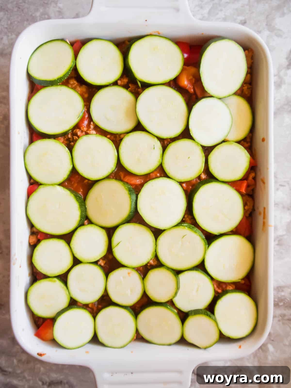 Rustic Turkey and Veggie Gratin 8 Fresh zucchini slices meticulously placed over a layer of meat sauce, creating another healthy component of the casserole.