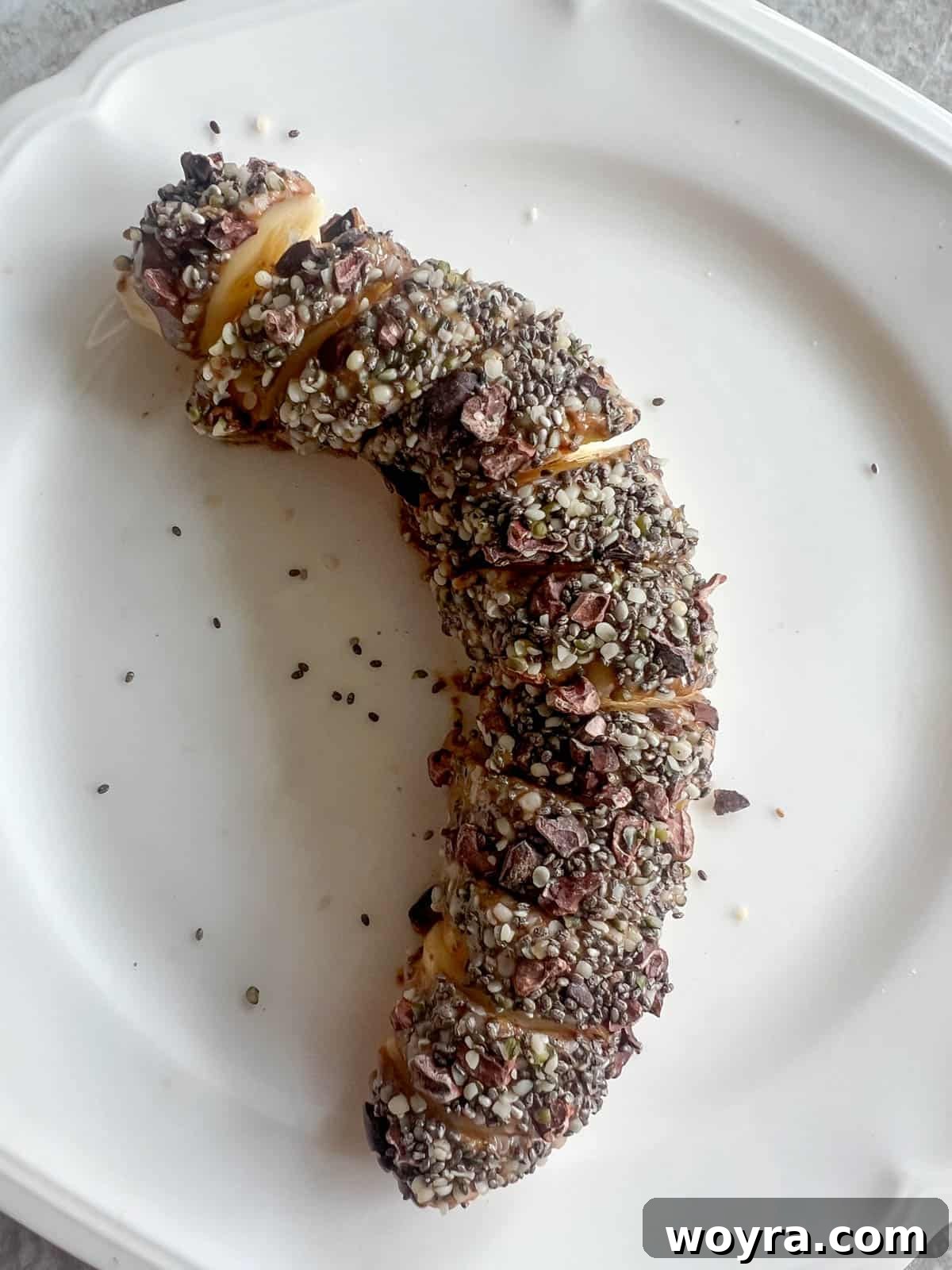 A whole banana, coated in toppings, now sliced into individual sushi-like pieces.