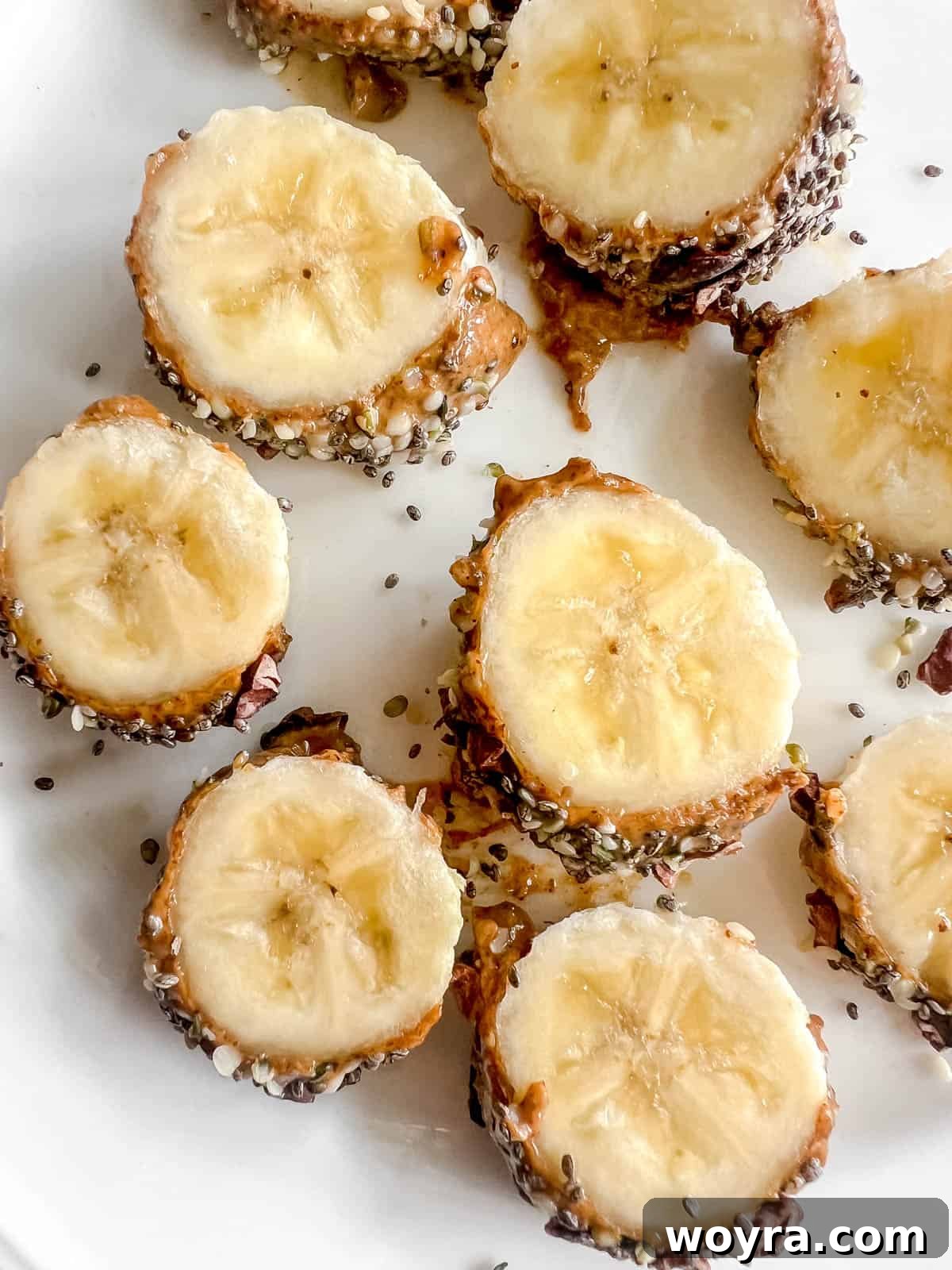 Multiple slices of breakfast banana sushi neatly arranged on a white plate, ready for serving.