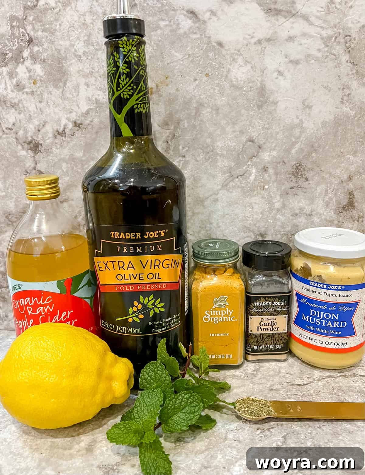 Golden Lemon Turmeric Mint Dressing 3 All the fresh and dry ingredients laid out on a table, ready to be combined for the lemon turmeric dressing with mint.