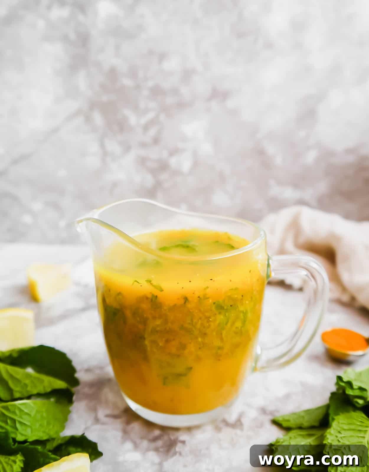 Golden Lemon Turmeric Mint Dressing 7 A jar of freshly made lemon turmeric dressing with mint, ready for storage in the refrigerator.
