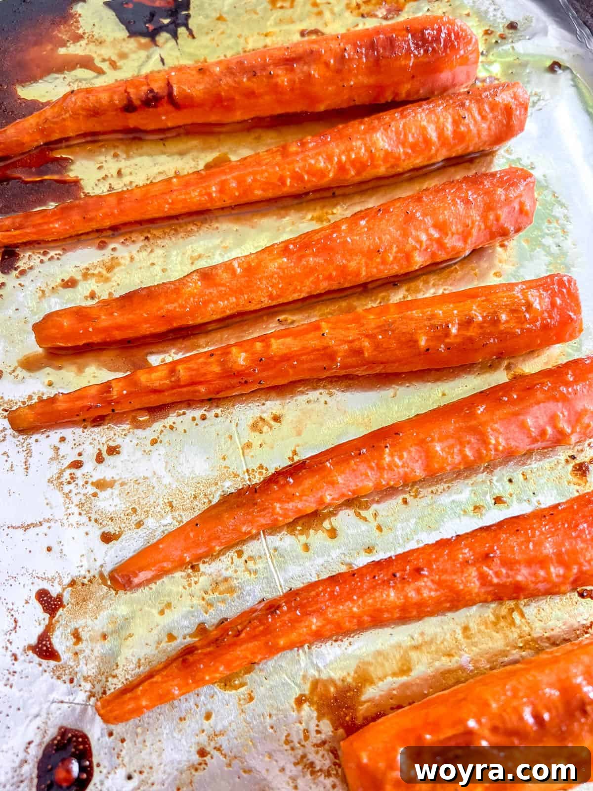 Close-up of roasted turmeric carrots with maple syrup, beautifully caramelized and vibrant.