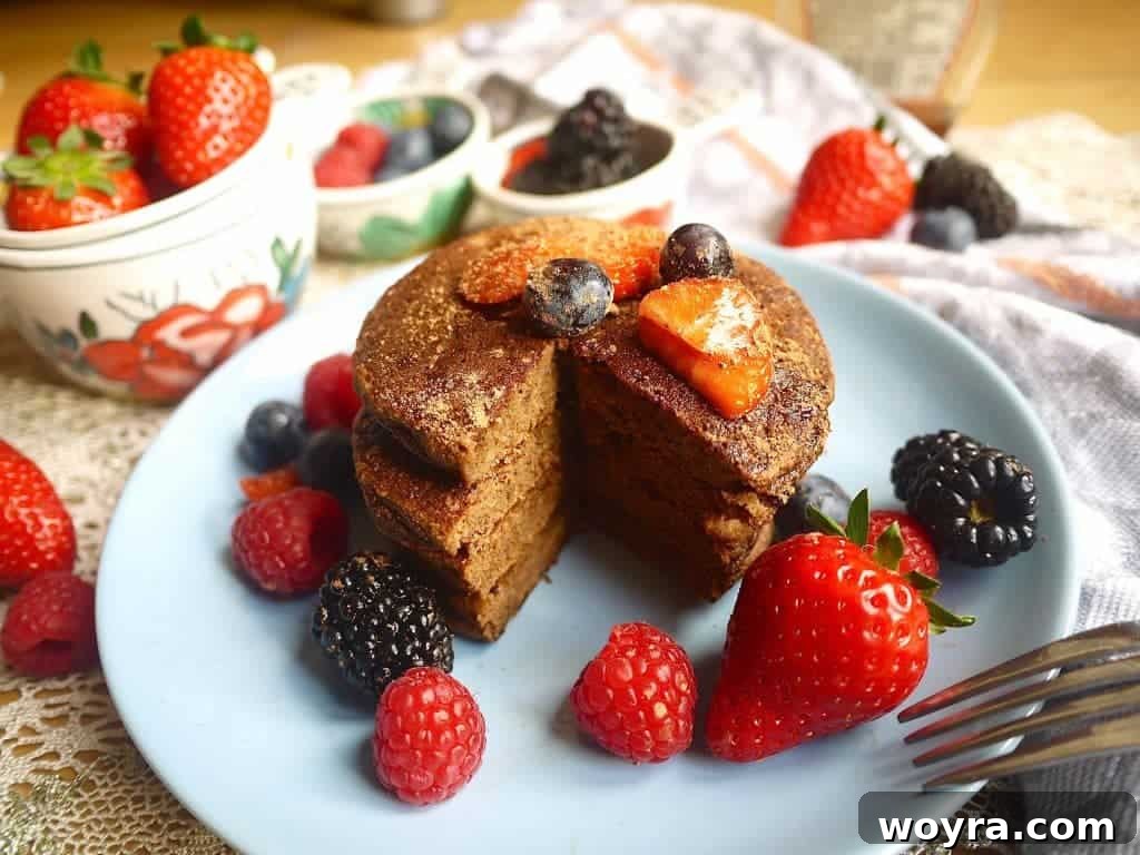 Decadent Paleo Chocolate Pancakes 6 Close-up of a single Chocolatey Cocoa Paleo Pancake on a white plate, ready to be enjoyed as a healthy treat
