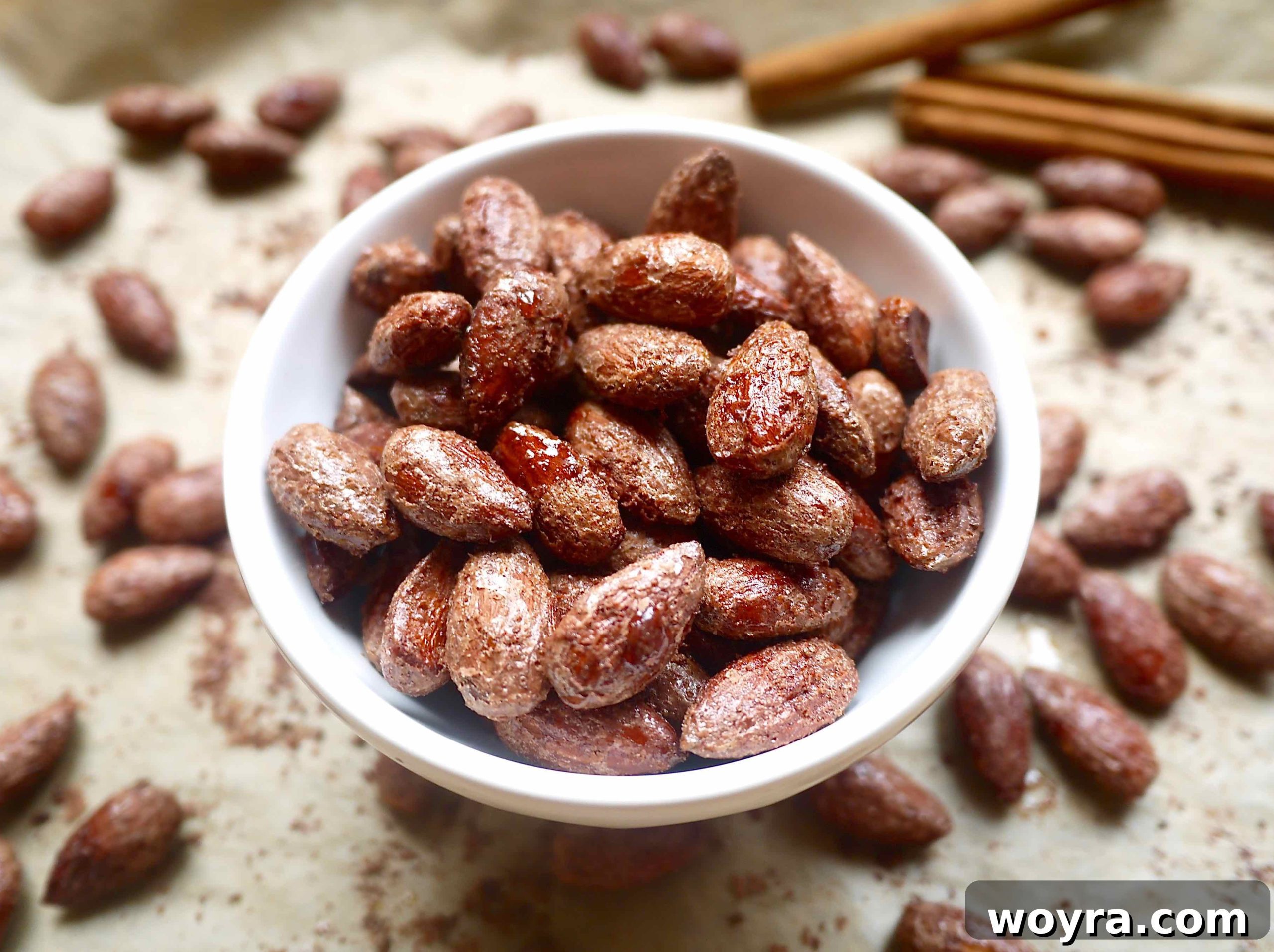 Warm Cinnamon Maple Roasted Almonds 7 A bowl filled with golden-brown cinnamon maple roasted almonds, ready to be enjoyed.