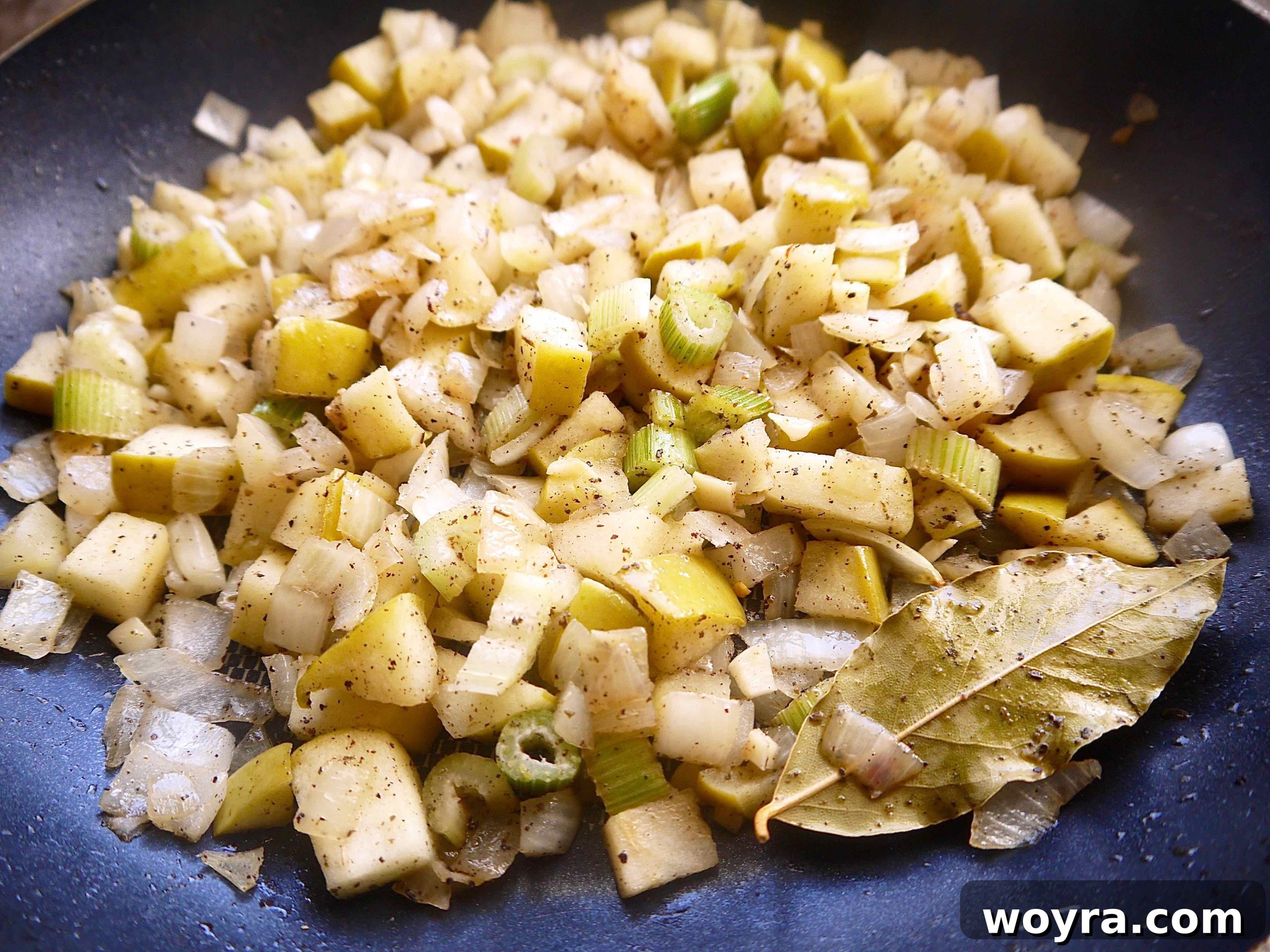 Sautéed fennel, onions, and apples mingling in a pan, infused with spices.