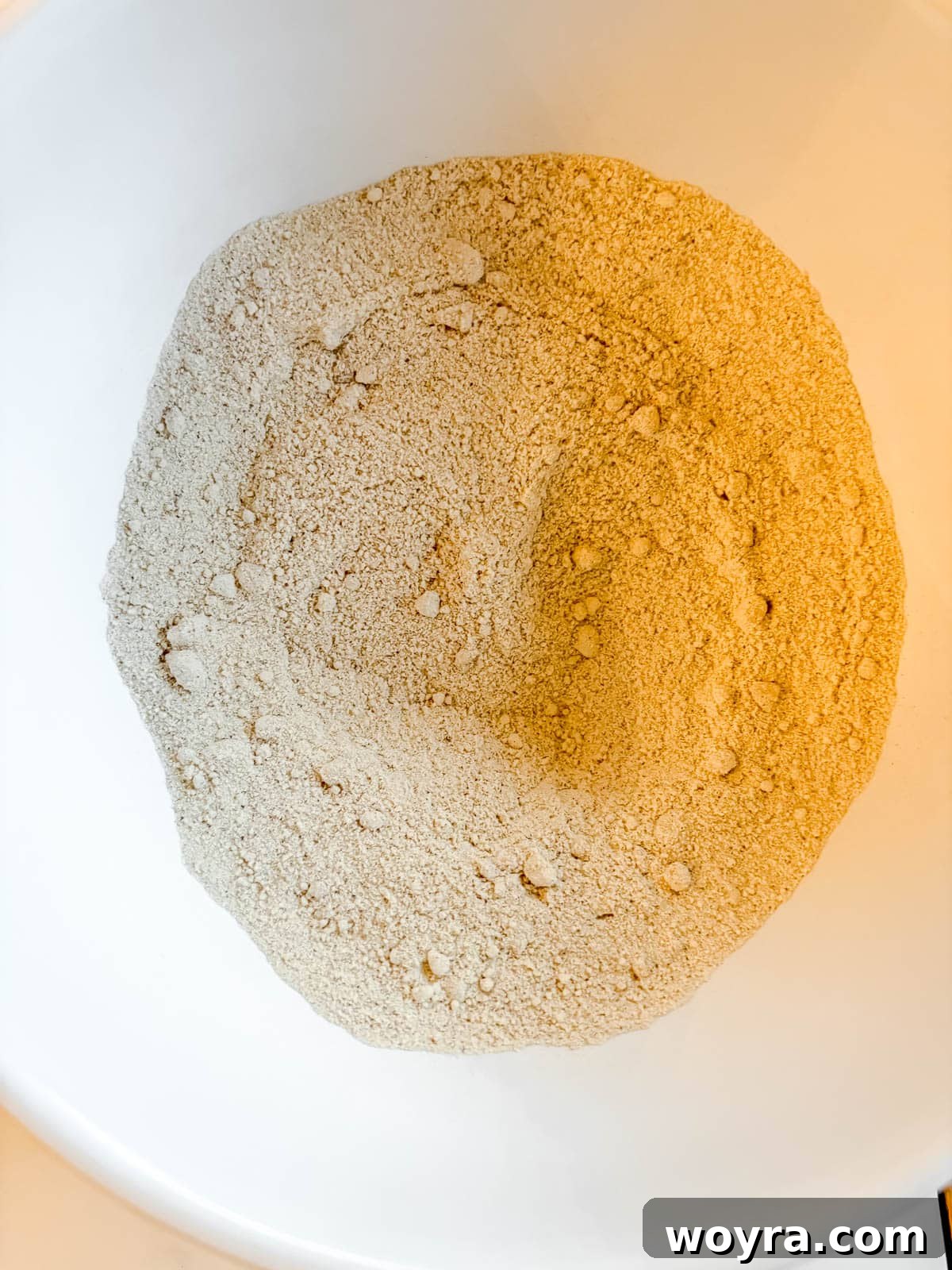 Rustic Chestnut Flour Coffee Cake 4 A bowl containing dry ingredients for chestnut flour coffee cake, including almond flour, chestnut flour, and spices.