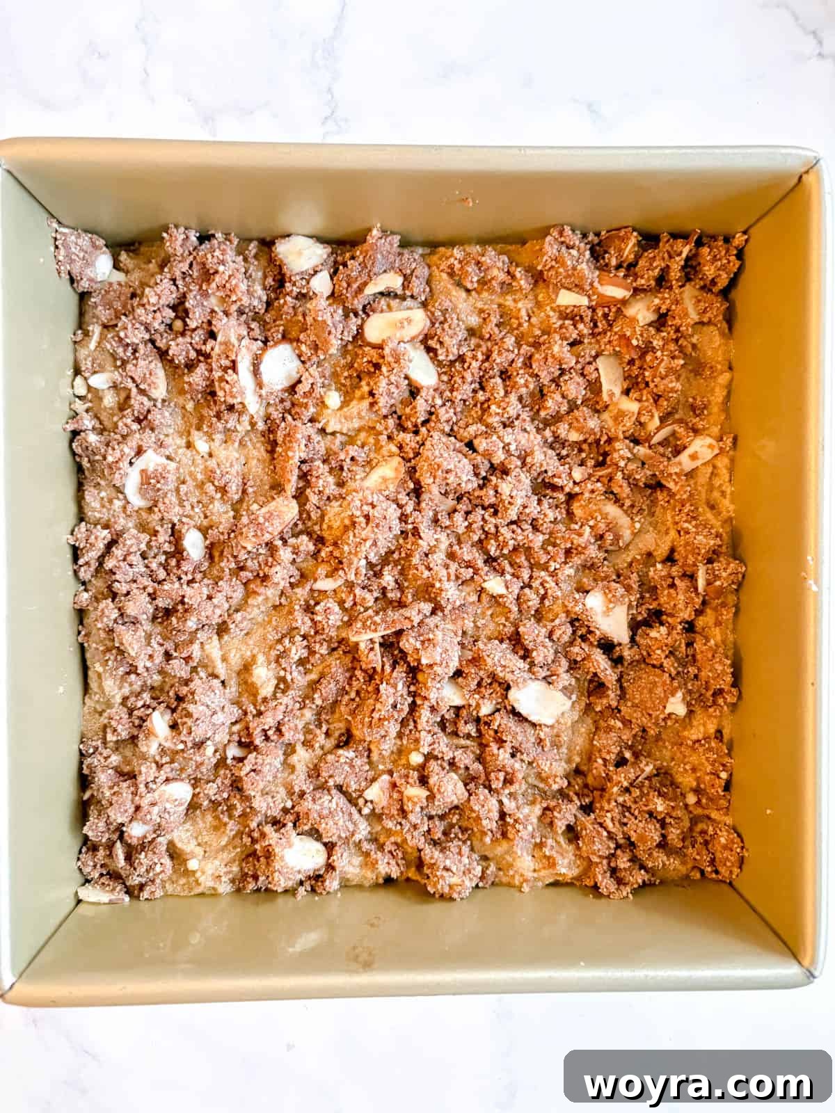Rustic Chestnut Flour Coffee Cake 8 Chestnut flour coffee cake batter in a pan with crumb topping spread over it, ready for baking.