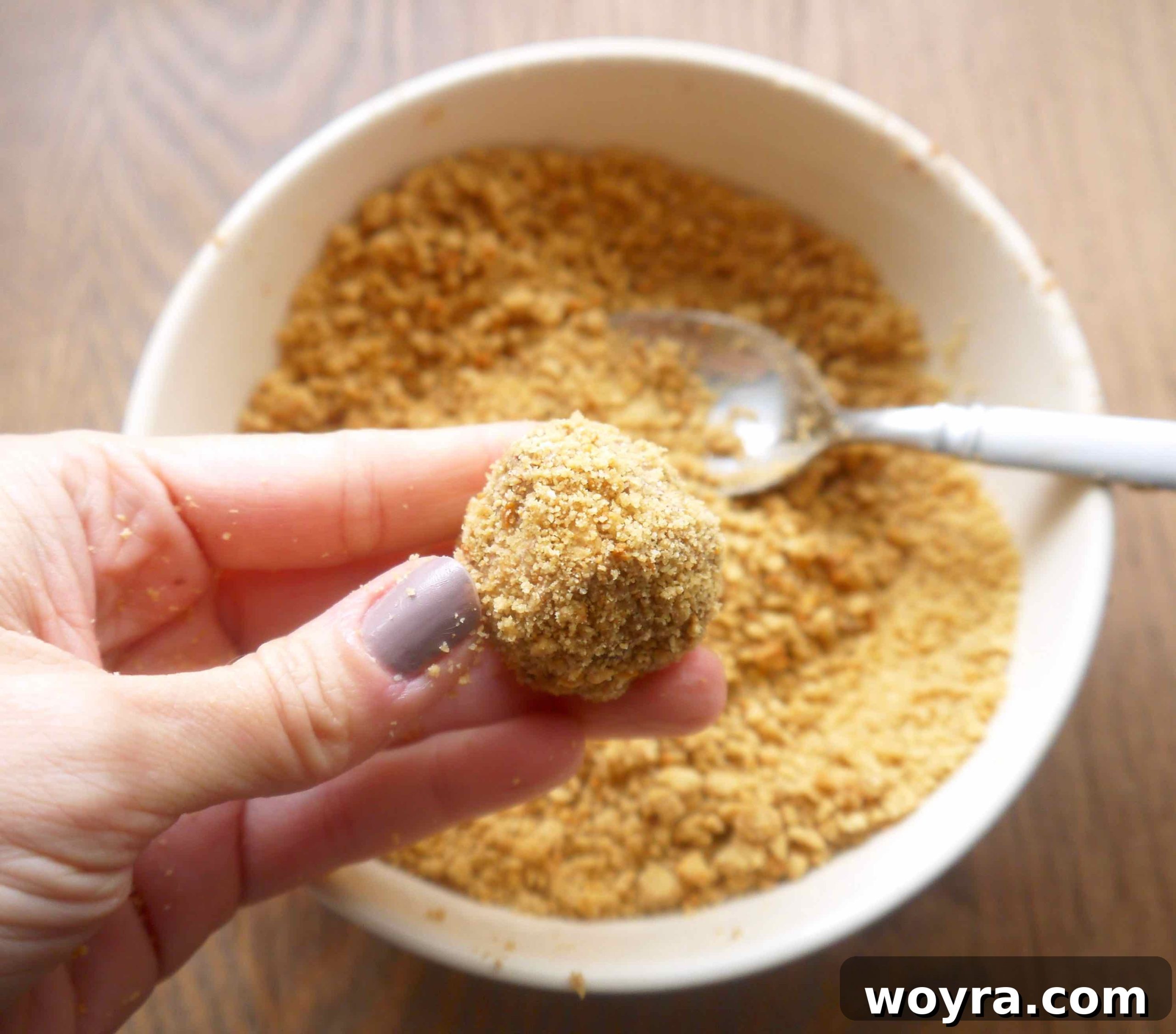 Decadent Paleo Chocolate Mousse Truffles 13 A finished, perfectly round chocolate mousse truffle, beautifully coated in cookie crumbs, ready to be served or chilled.