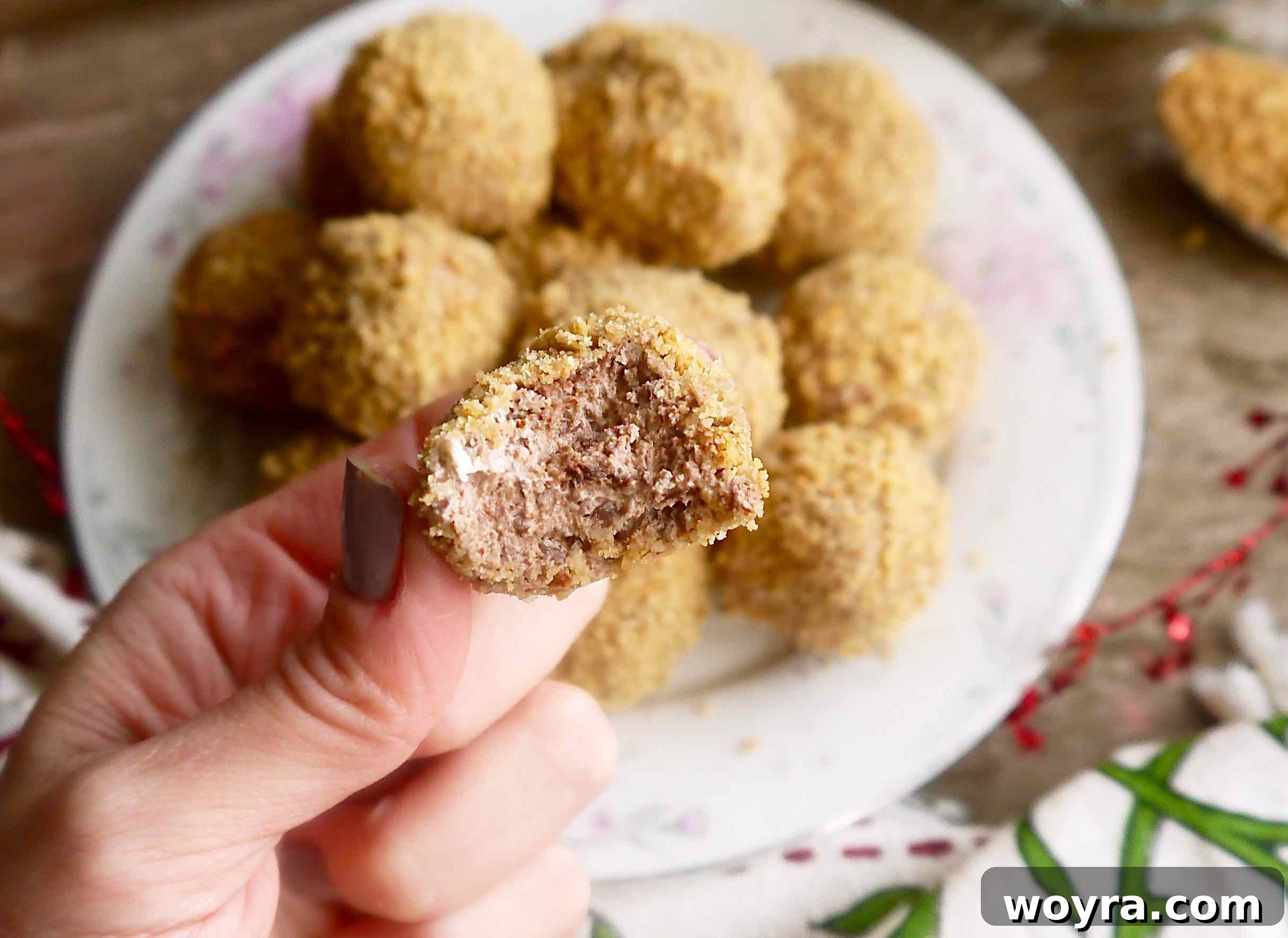 Decadent Paleo Chocolate Mousse Truffles 14 A Paleo chocolate mousse truffle, with a tempting bite taken out, showcasing its rich, creamy filling and crunchy exterior.