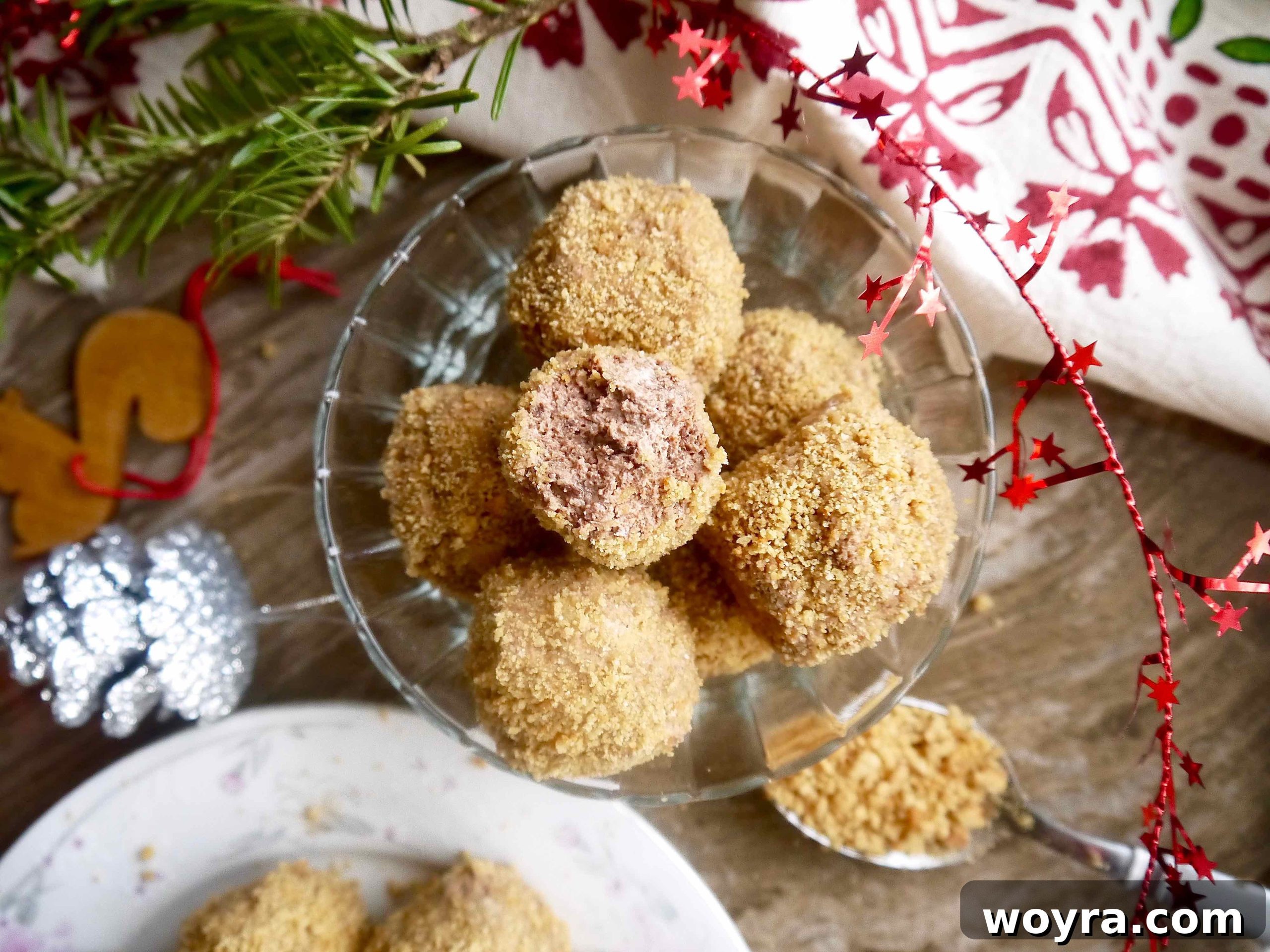 Decadent Paleo Chocolate Mousse Truffles 3 A delectable Paleo Chocolate Mousse Truffle, with a small bite taken out to reveal its creamy chocolate interior and crunchy cookie coating.