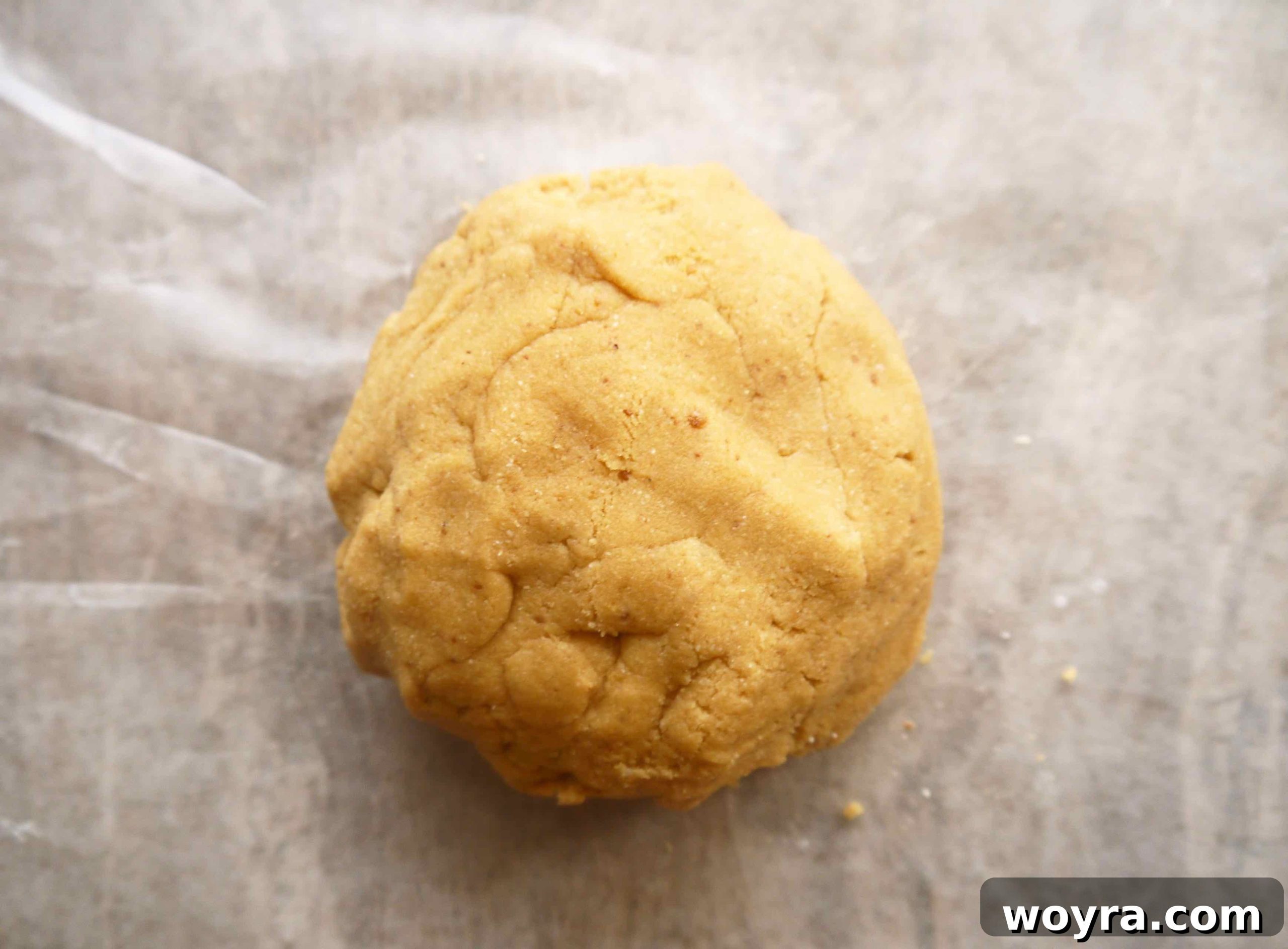 Decadent Paleo Chocolate Mousse Truffles 5 Smooth, perfectly formed cookie dough, rolled into a neat ball, signifying its readiness for shaping.