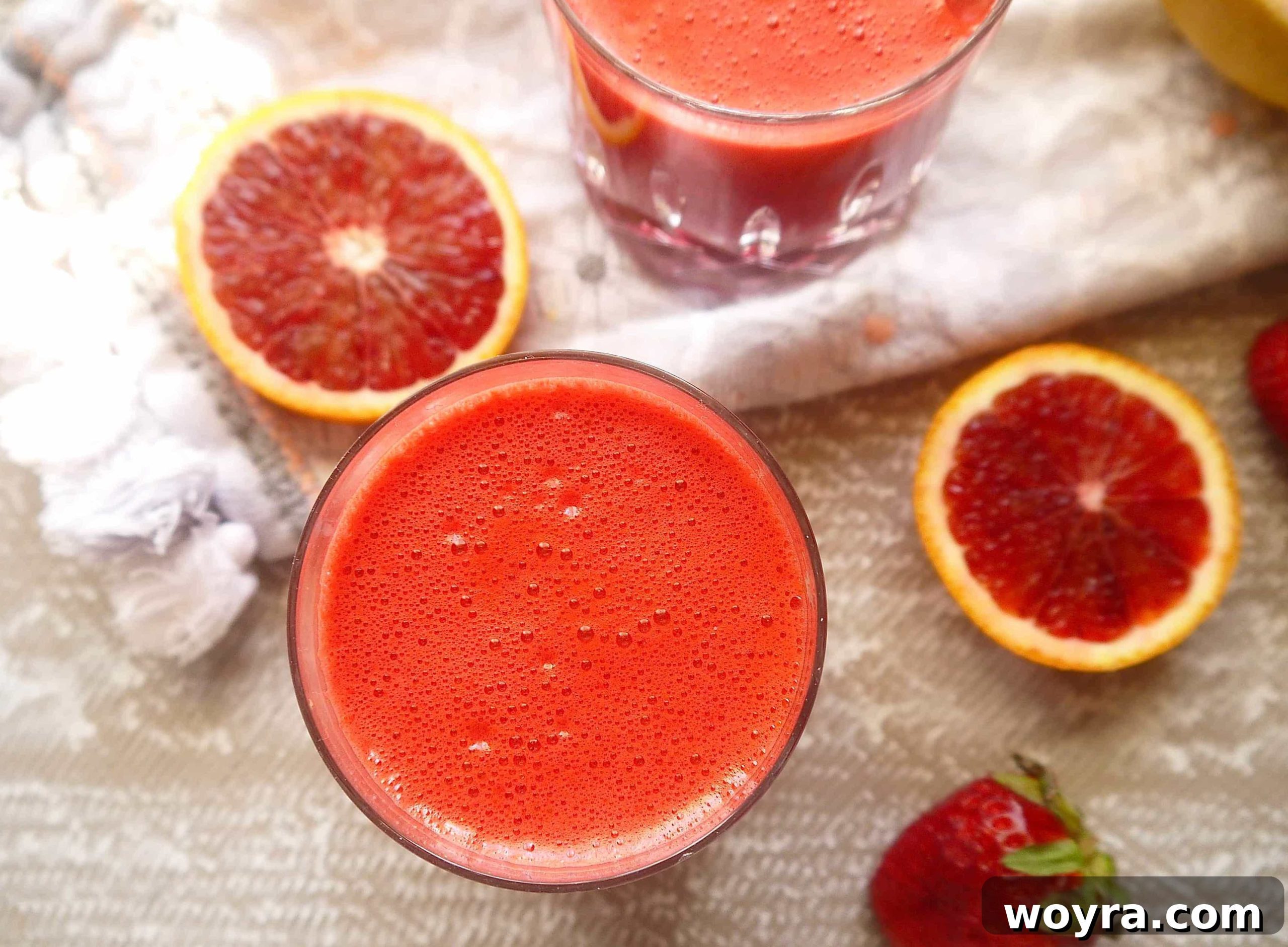 Red Root Berry Bliss 4 An aerial view of a single glass filled with deep pink beet and carrot juice, highlighting its rich color.