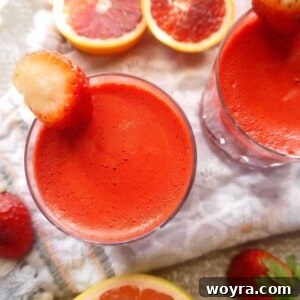 Red Root Berry Bliss 6 Strawberry Apple Beet Carrot Juice in a glass.