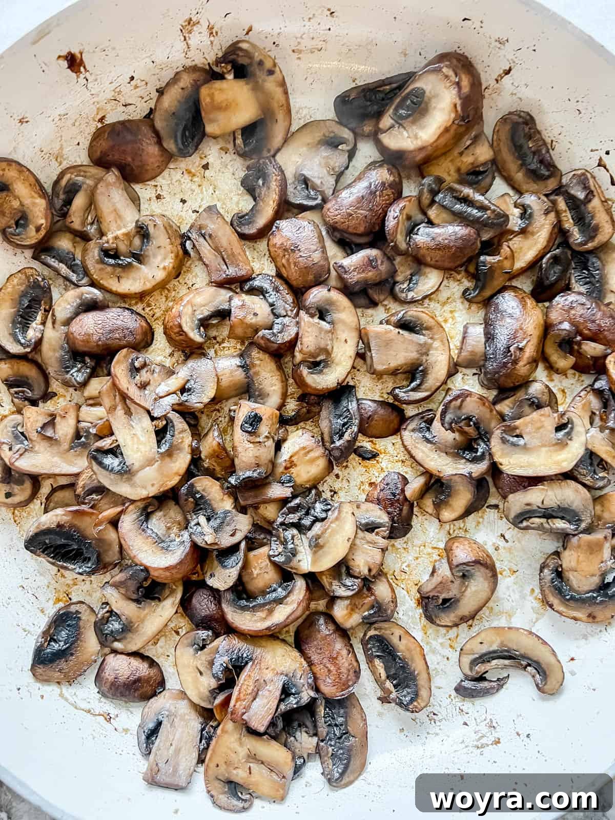 Creamy Vegan Paleo Mushroom Sauce 5 Mushrooms in a pan, after cooking, having released their moisture and started to brown.