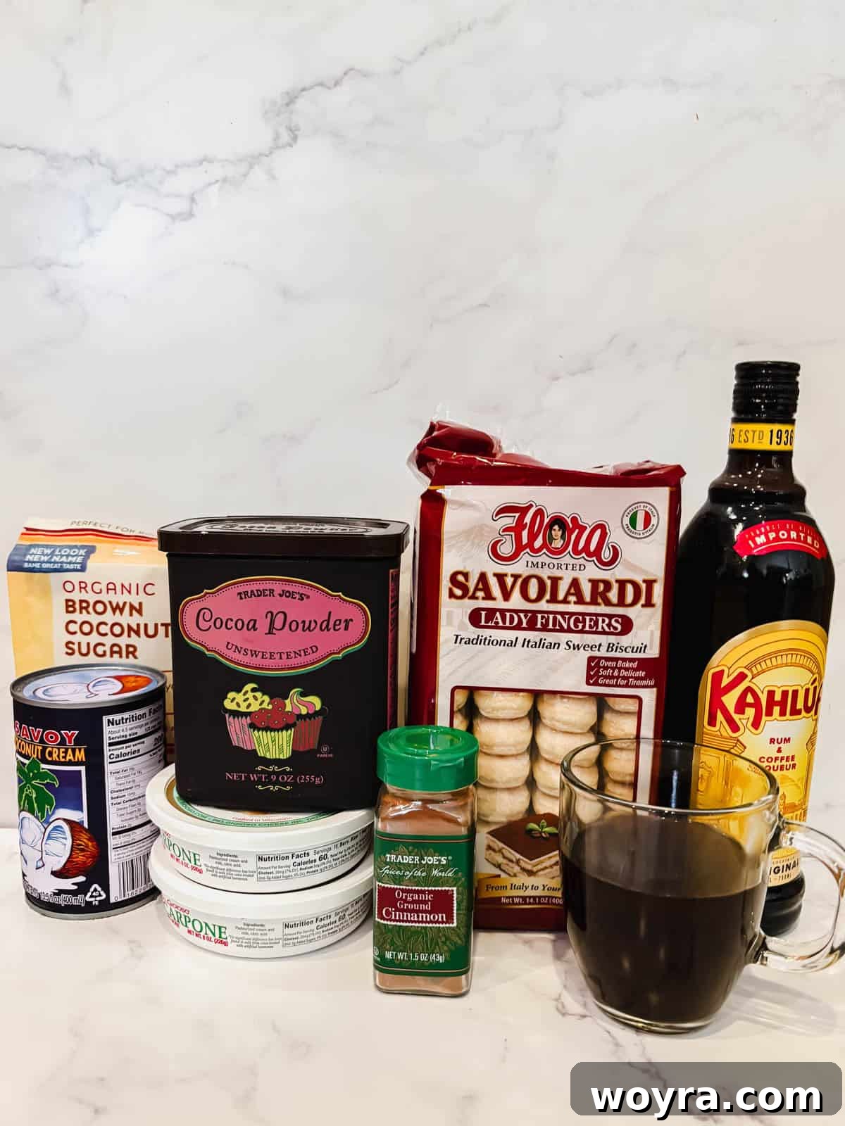 Tropical Coconut Tiramisu 3 Key ingredients laid out for making Coconut Cream Tiramisu, including coconut cream, mascarpone, coffee, Kahlúa, and ladyfingers.