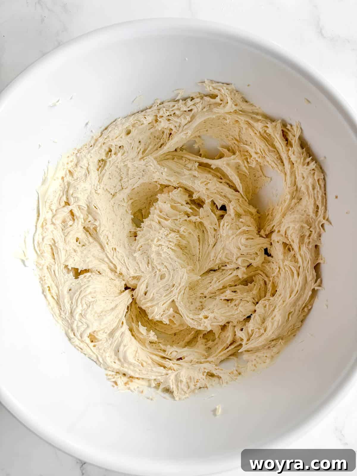 Tropical Coconut Tiramisu 4 Mascarpone cheese being mixed with coconut sugar in a bowl.