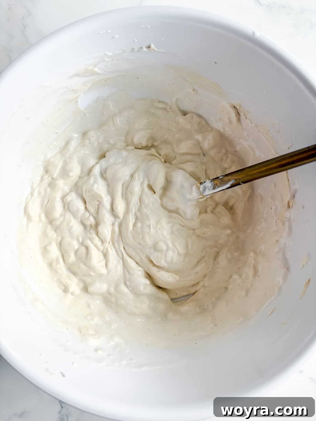 Tropical Coconut Tiramisu 5 Whipped coconut cream being gently folded into the mascarpone and coconut sugar mixture.