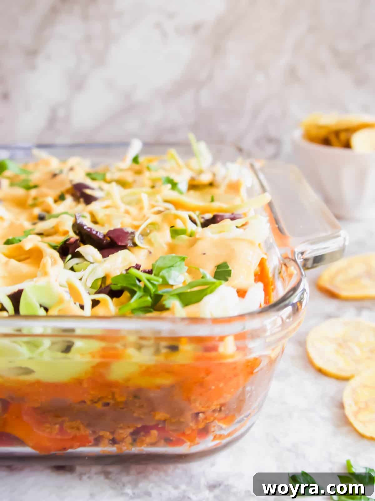 Ultimate Dairy-Free 7 Layer Turkey Taco Dip 3 Side angle of healthy taco dip where you can clearly see all the distinct layers, ready to be scooped.