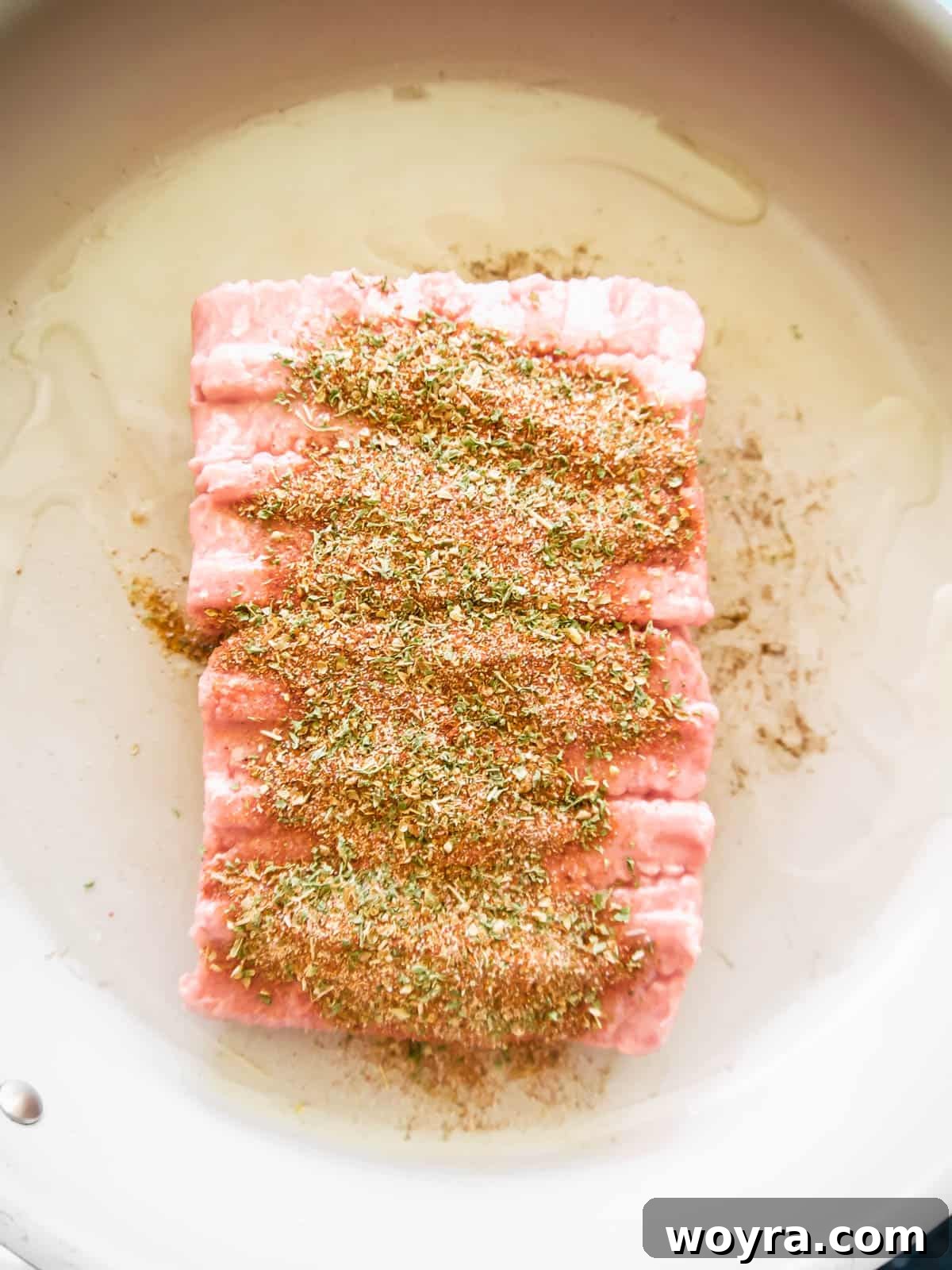 Ultimate Dairy-Free 7 Layer Turkey Taco Dip 4 Ground turkey in a pan with spices being added.