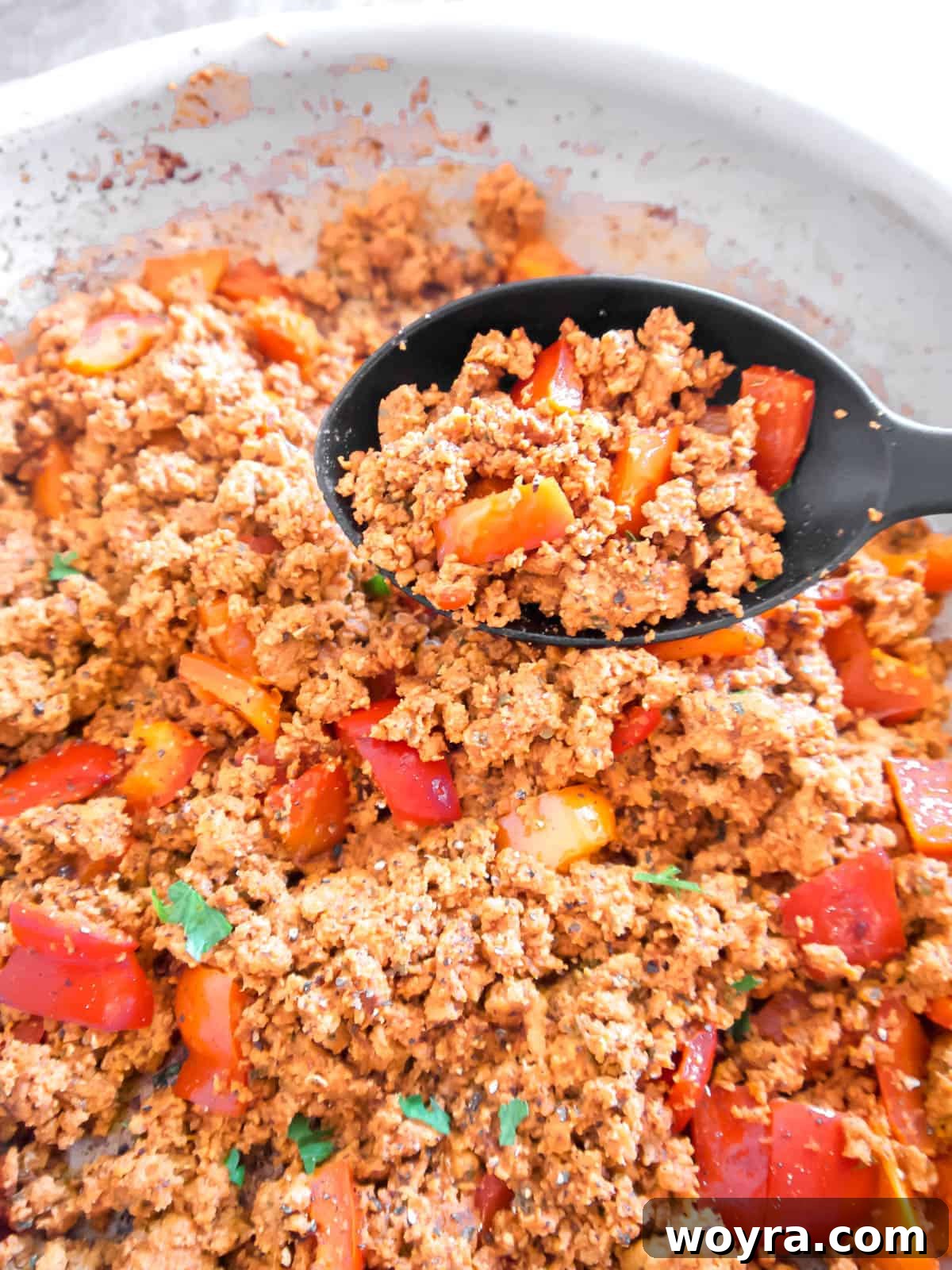 Ultimate Dairy-Free 7 Layer Turkey Taco Dip 6 Ground turkey and bell peppers cooked and browned in a pan.