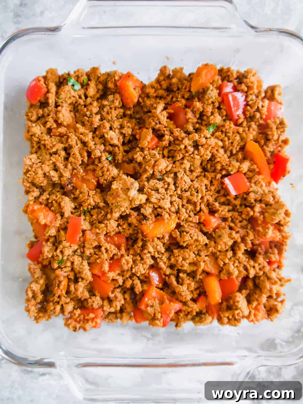 Ultimate Dairy-Free 7 Layer Turkey Taco Dip 7 The first layer, cooked ground turkey, spread evenly in a baking dish.