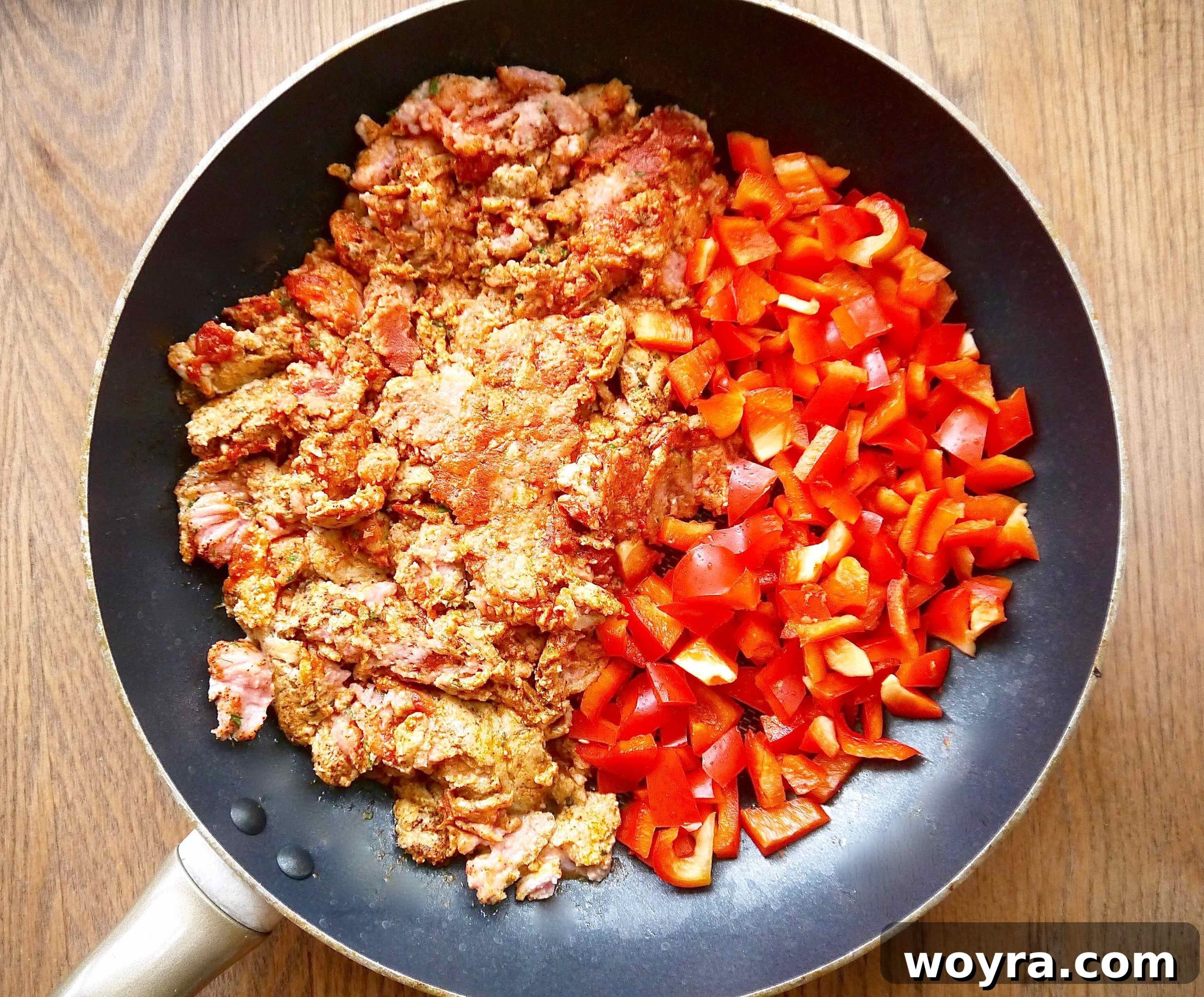 Ground turkey and diced red peppers ready to be cooked in a pan.