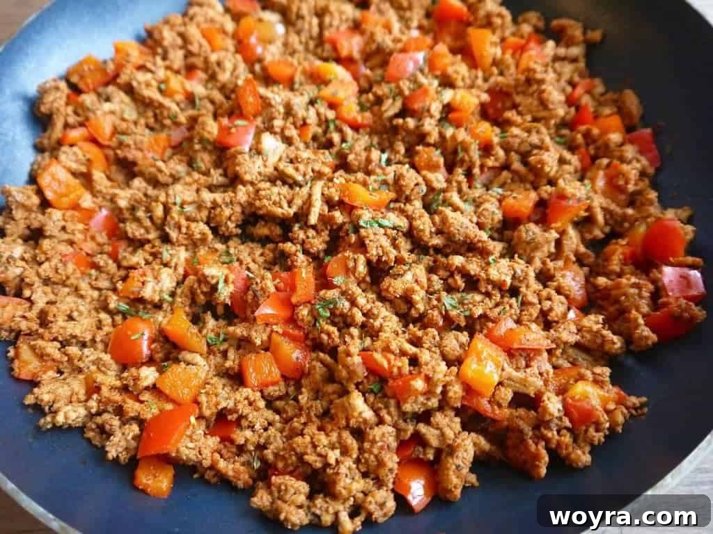 The seasoned ground turkey taco meat cooking and browning in the pan.
