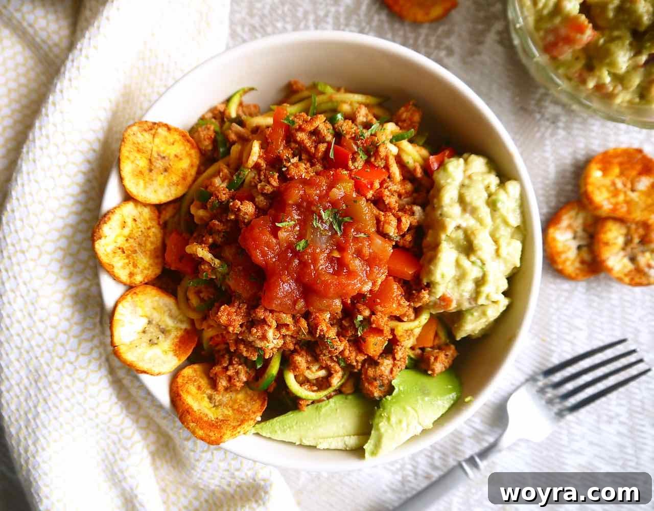 Close-up of zucchini noodles perfectly seasoned with ground turkey taco meat.
