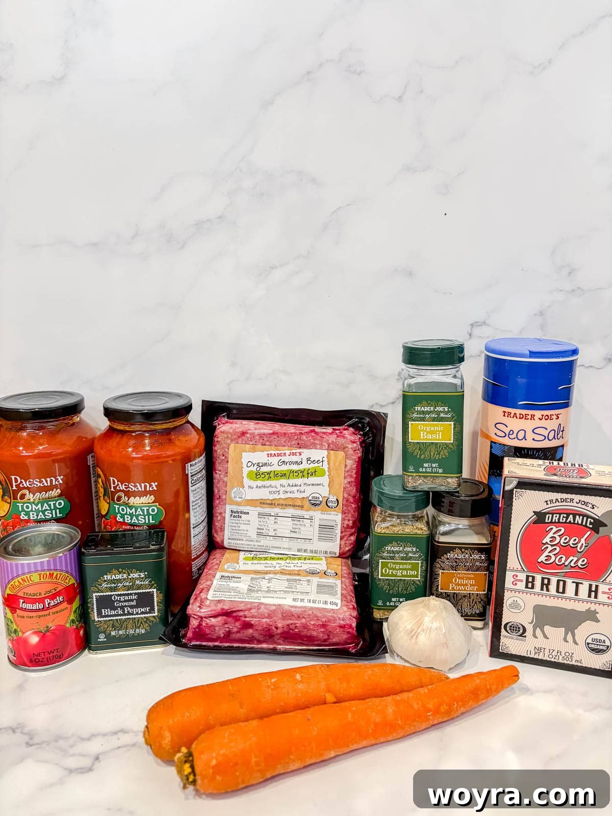 Meaty Slow Cooker Spaghetti Sauce 3 Fresh ingredients for slow cooker spaghetti sauce with ground beef, laid out on a cutting board.