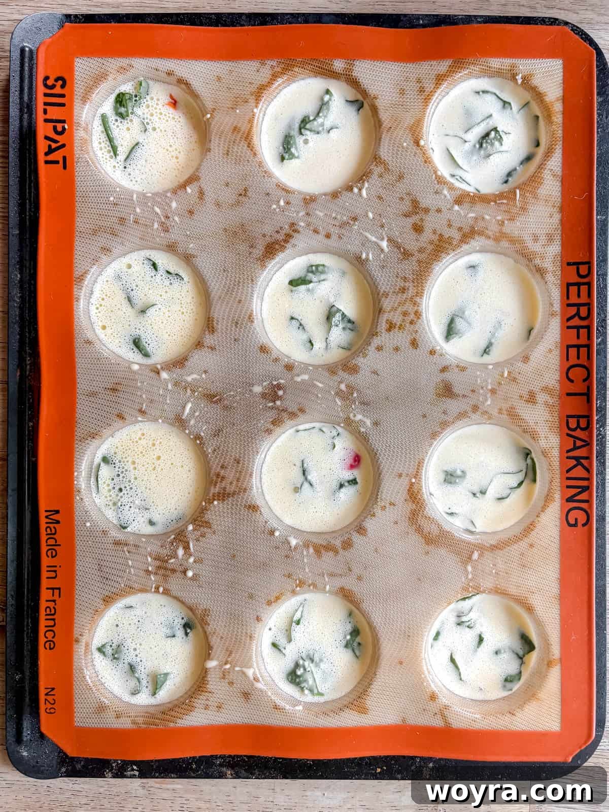 High-Protein Cottage Cheese Egg Bites with Spinach & Pepper 6 Cottage cheese egg bites before cooking.